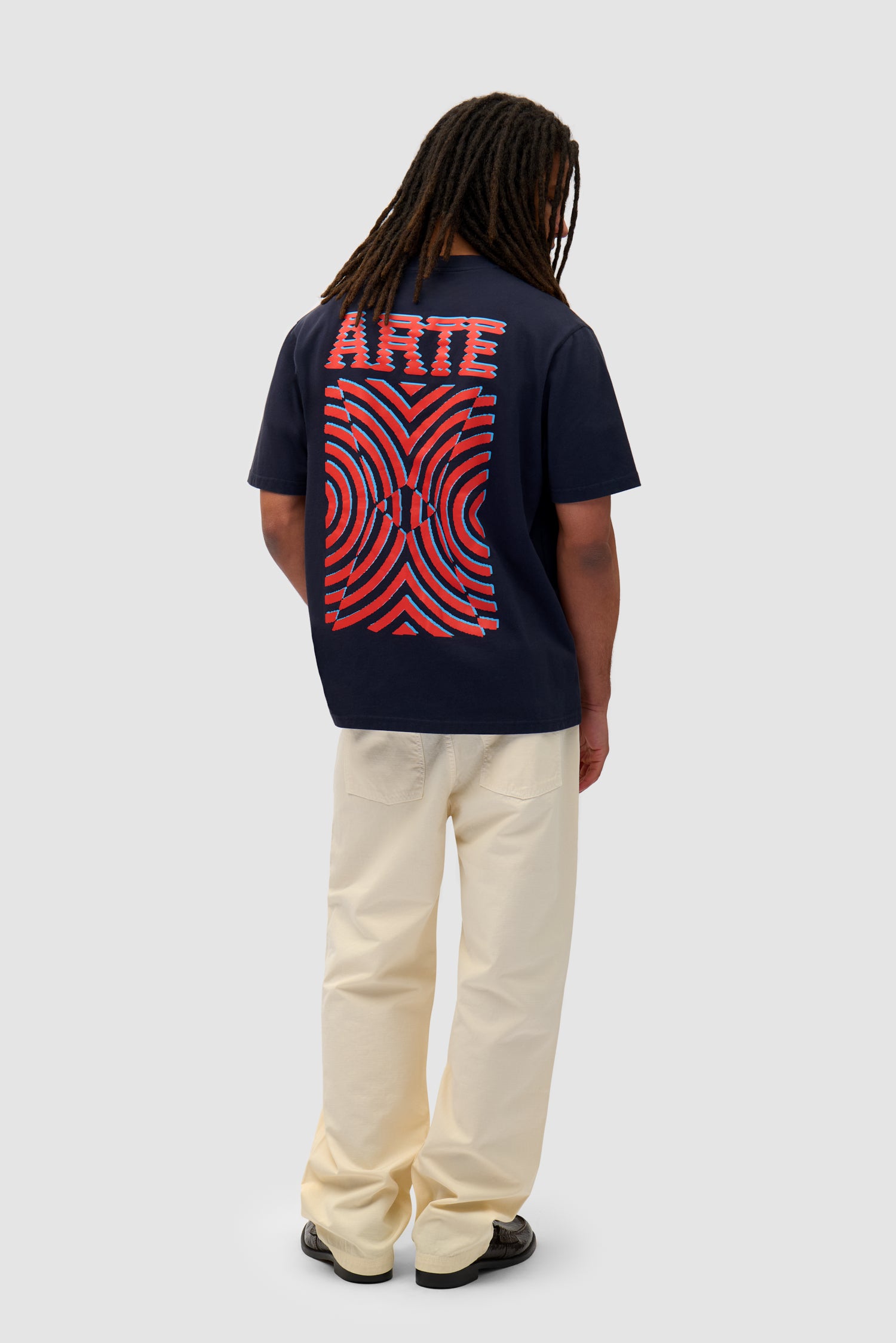 Mural Back Print T-shirt in Navy worn by a model, full-body side view