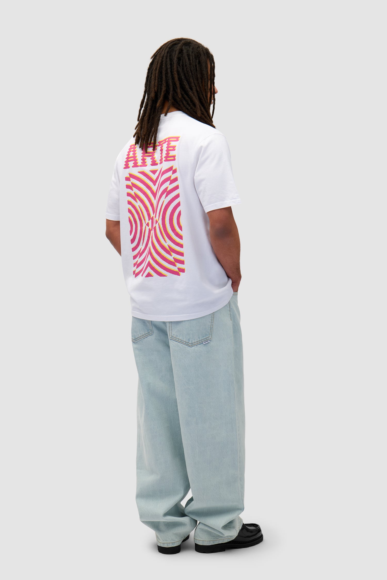 Mural Back Print T-shirt in White worn by a model, full-body side view