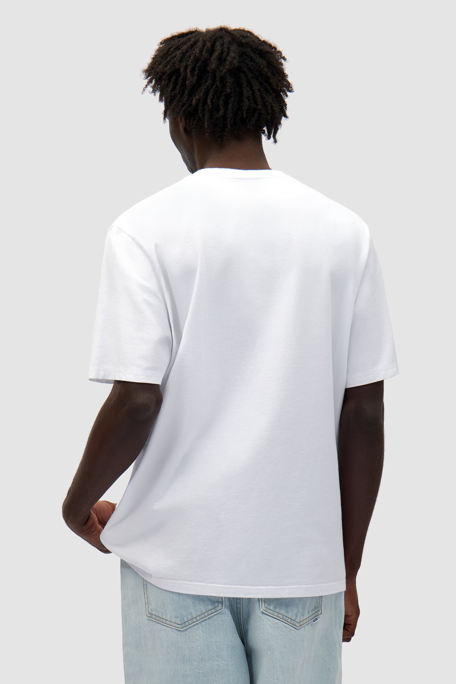 Duo Print Logo T-shirt in White worn by a model, half-body back view