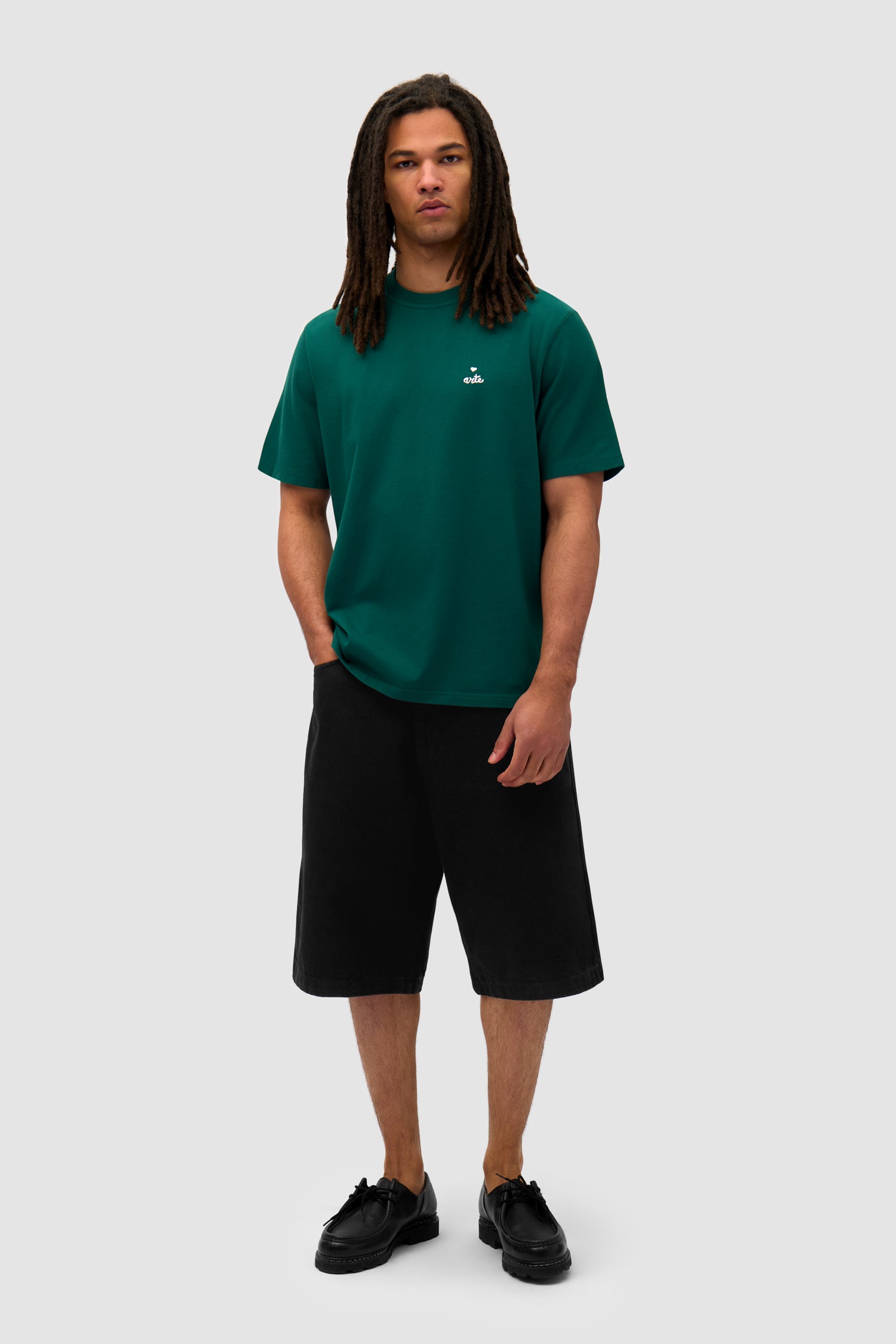 Heart Logo T-shirt in Green worn by a model, full-body front view