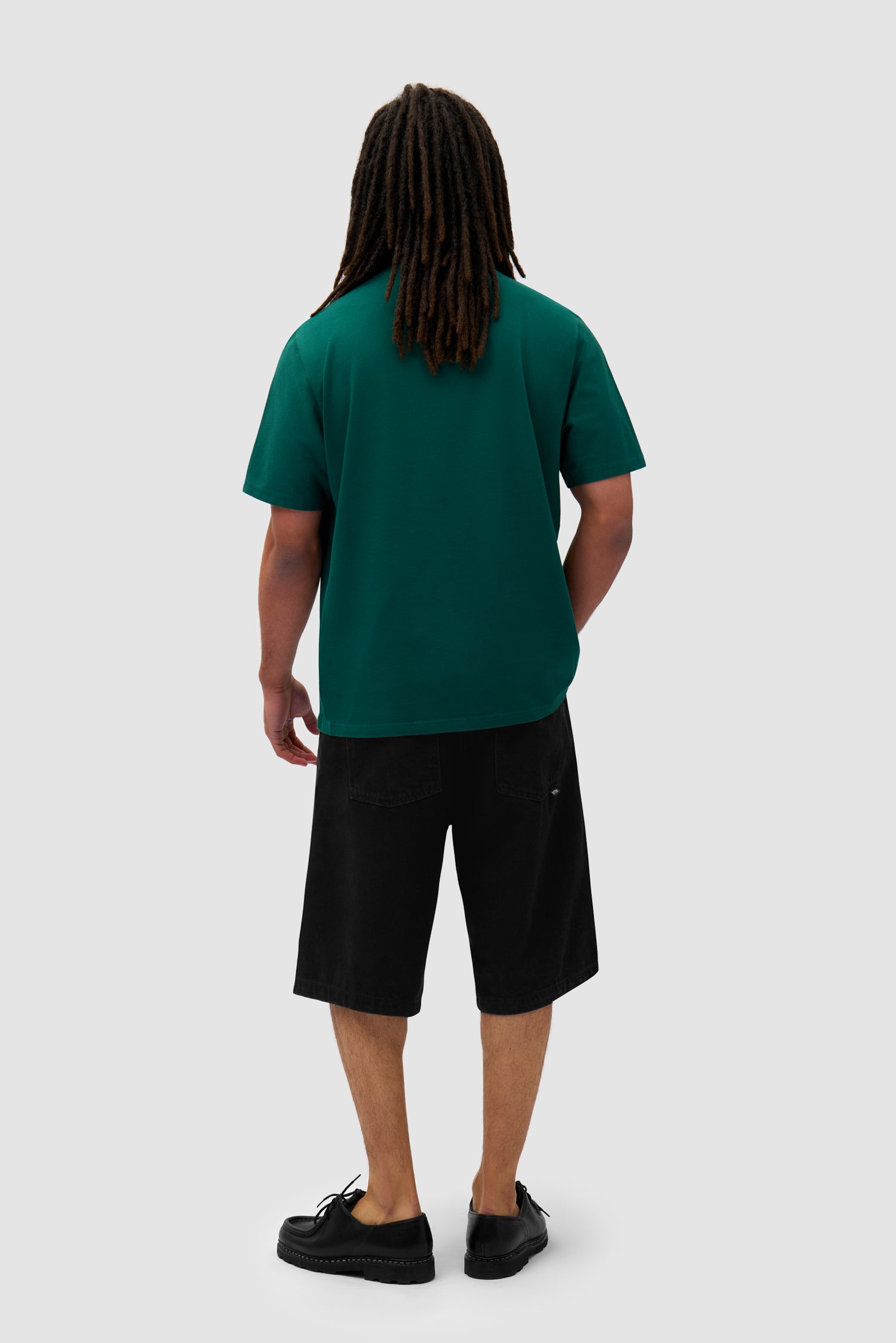 Heart Logo T-shirt in Green worn by a model, full-body back view