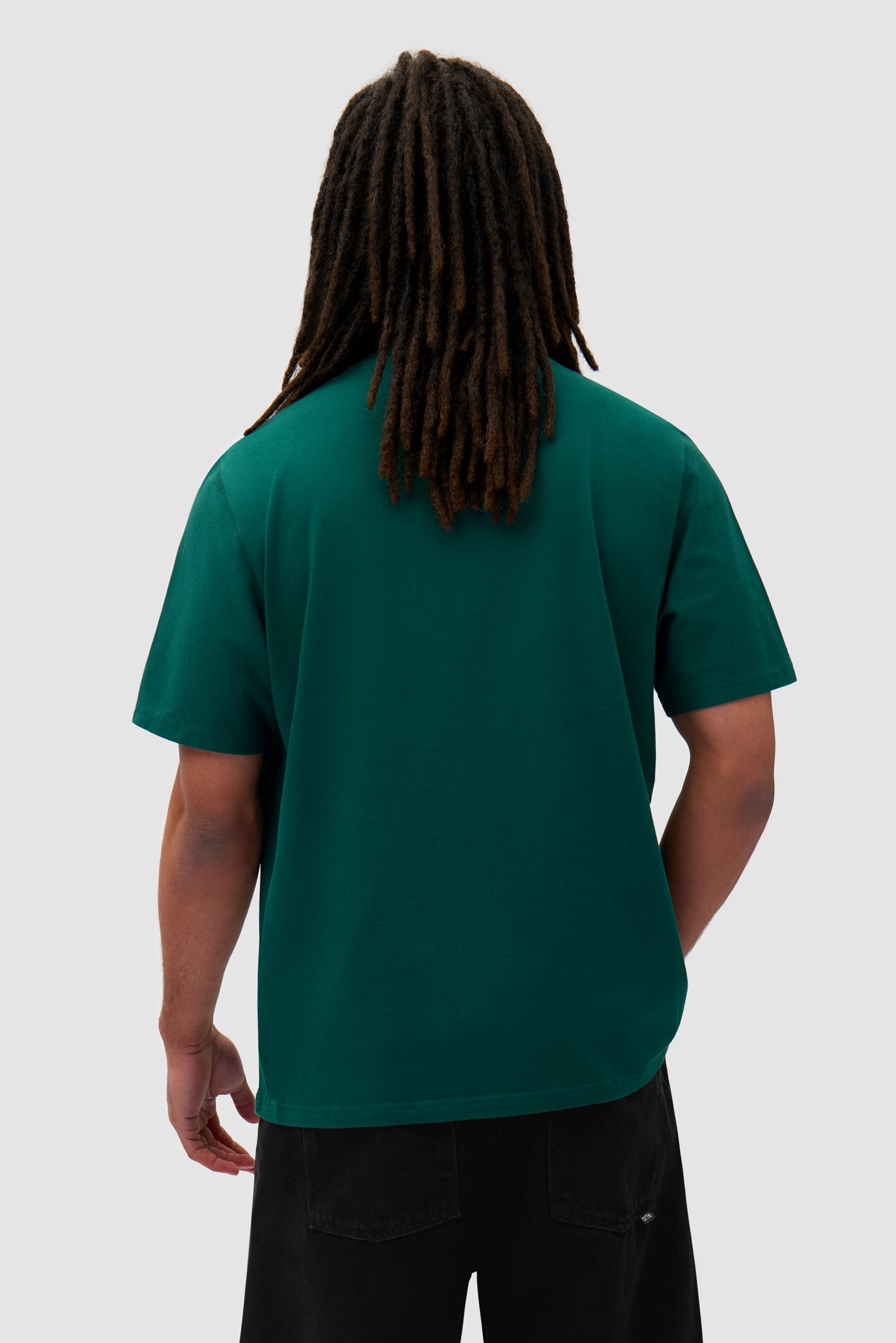 Heart Logo T-shirt in Green worn by a model, half-body back view