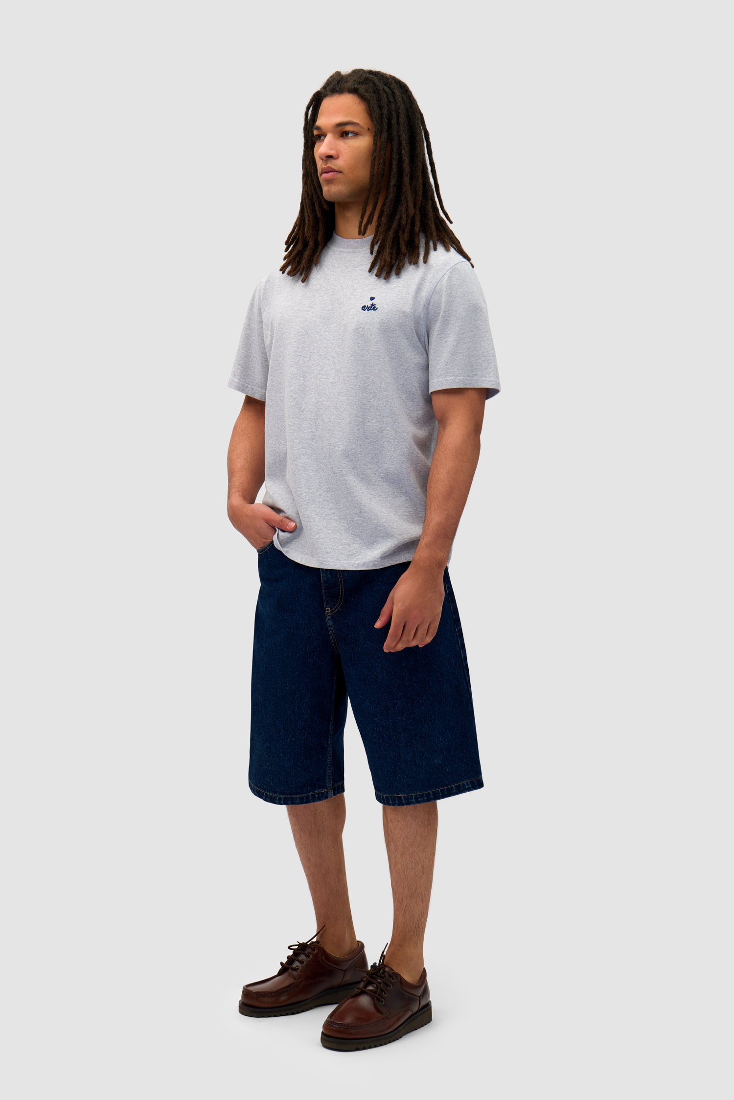 Heart Logo T-shirt in Grey worn by a model, full-body side view