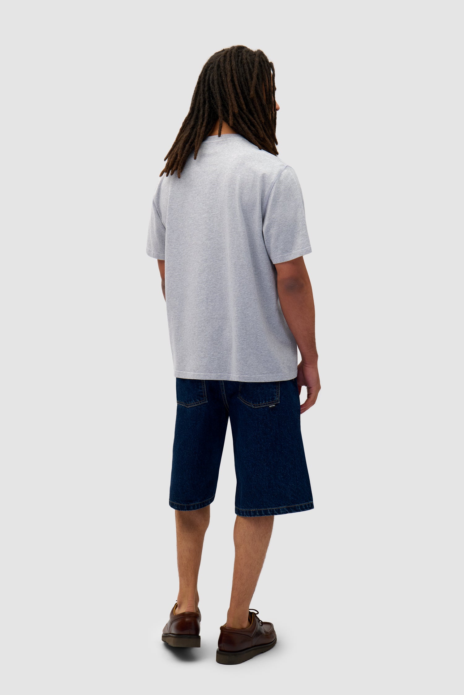 Heart Logo T-shirt in Grey worn by a model, full-body back view