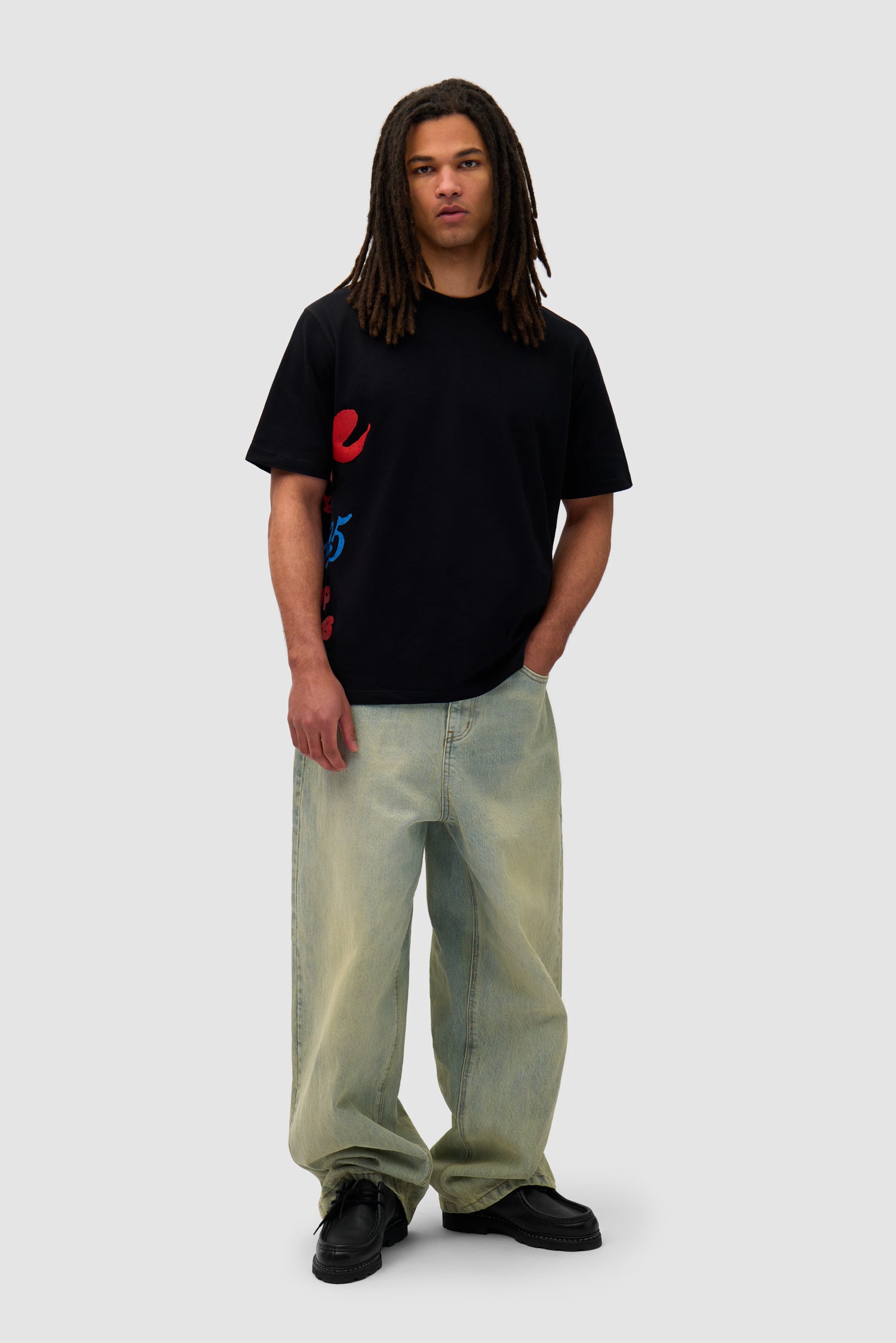 Side Print T-shirt in Black worn by a model, full-body front view