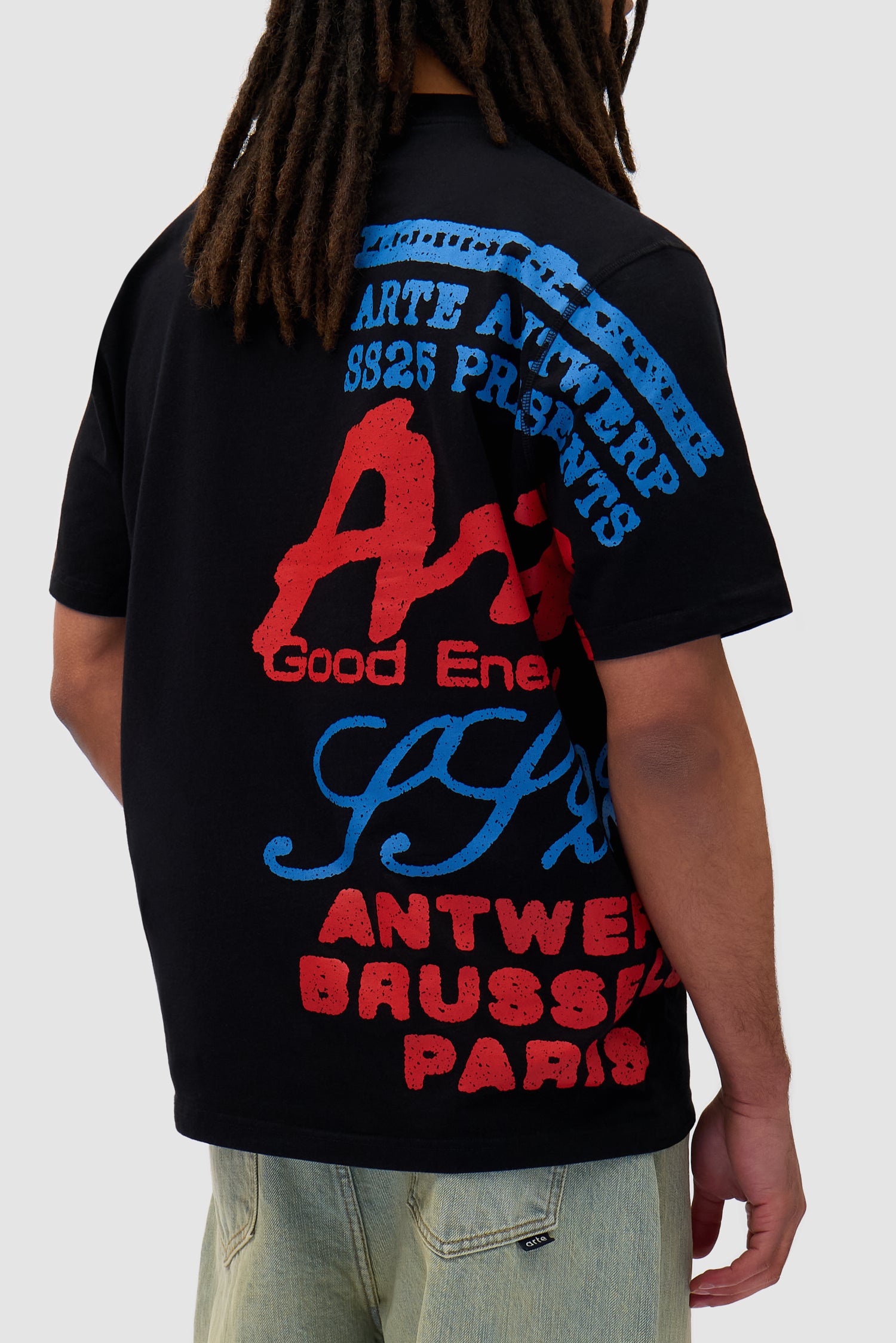 Side Print T-shirt in Black worn by a model, full-body back view