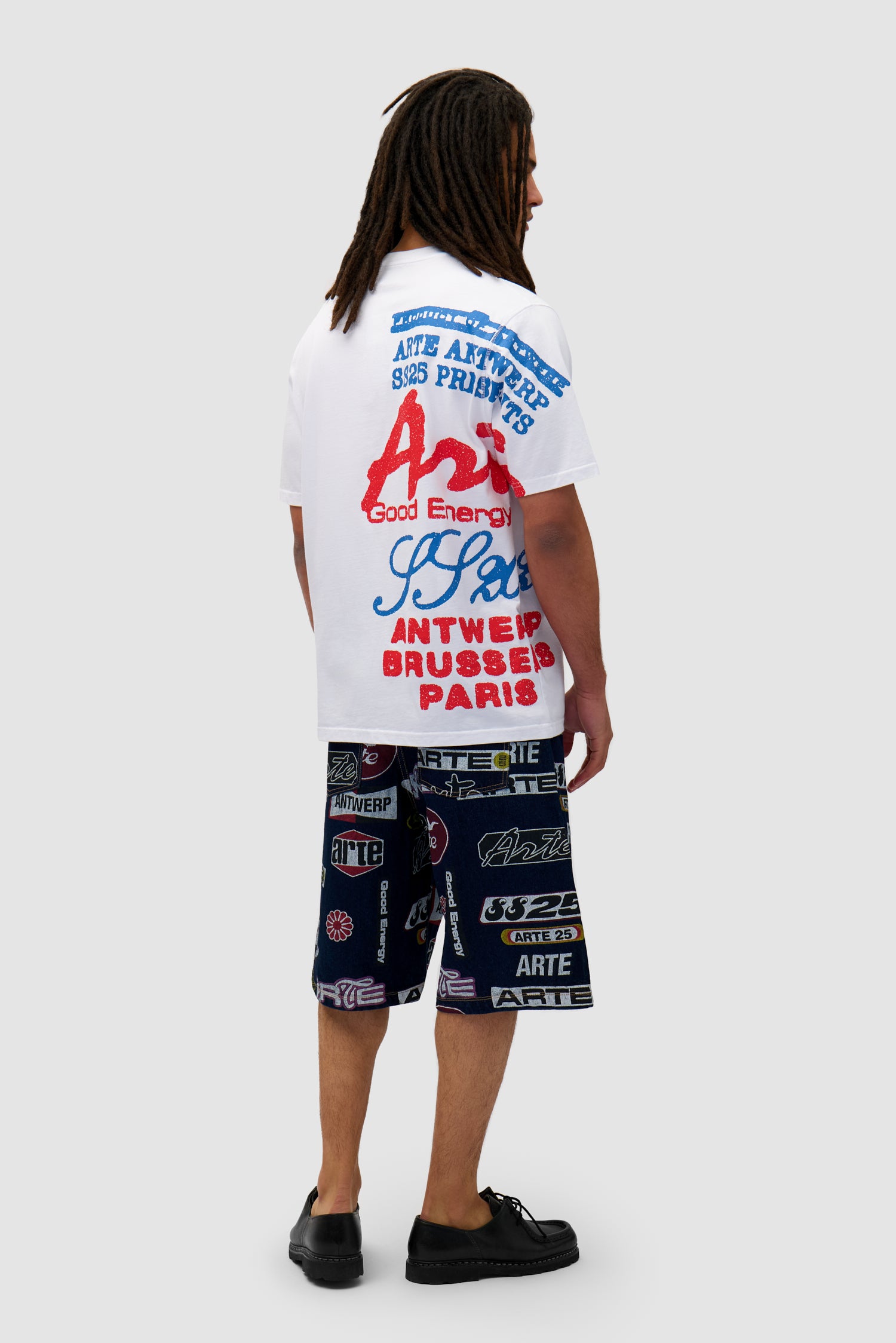 Side Print T-shirt in White worn by a model, full-body side view