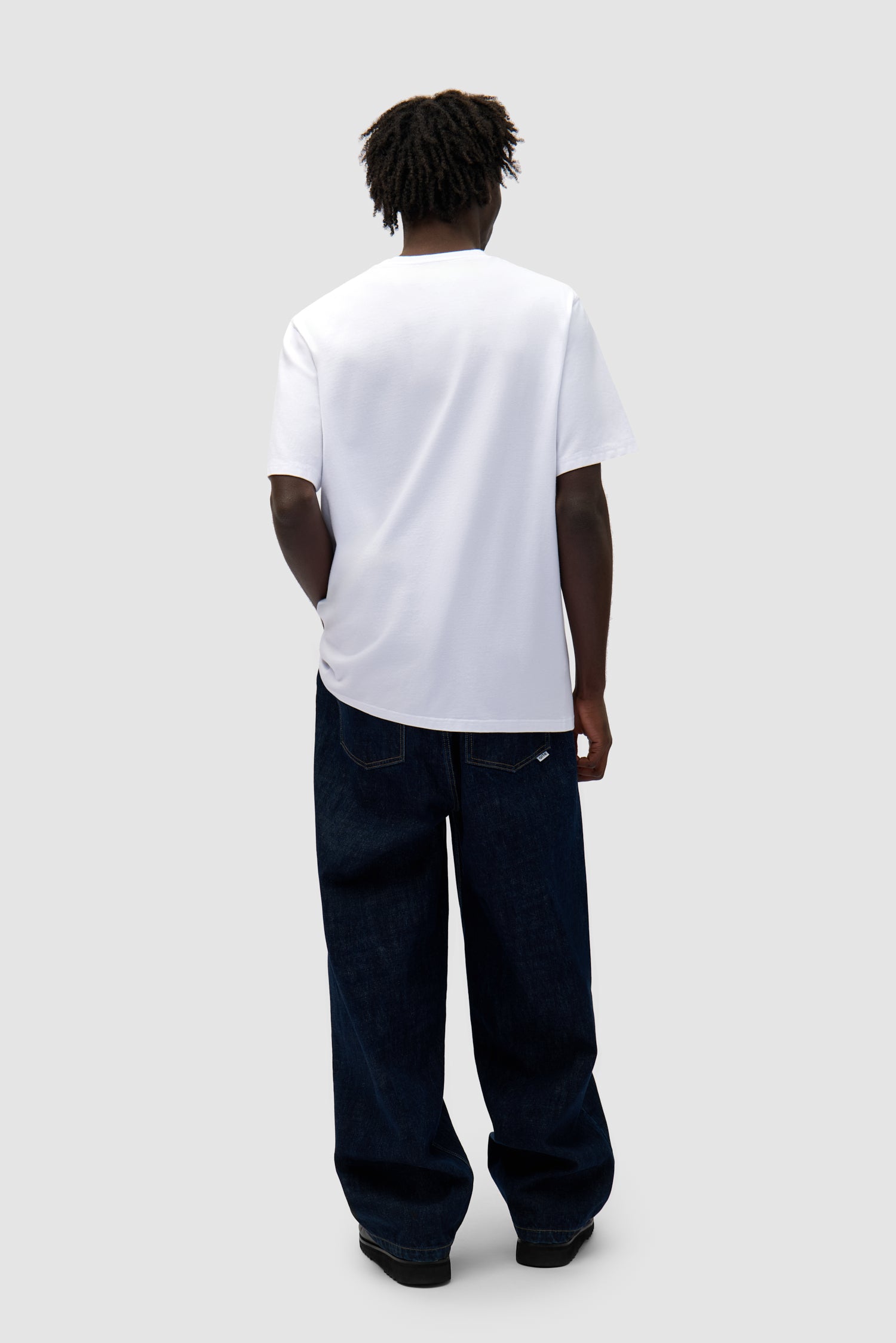 Big Flower T-shirt in White worn by a model, full-body back view