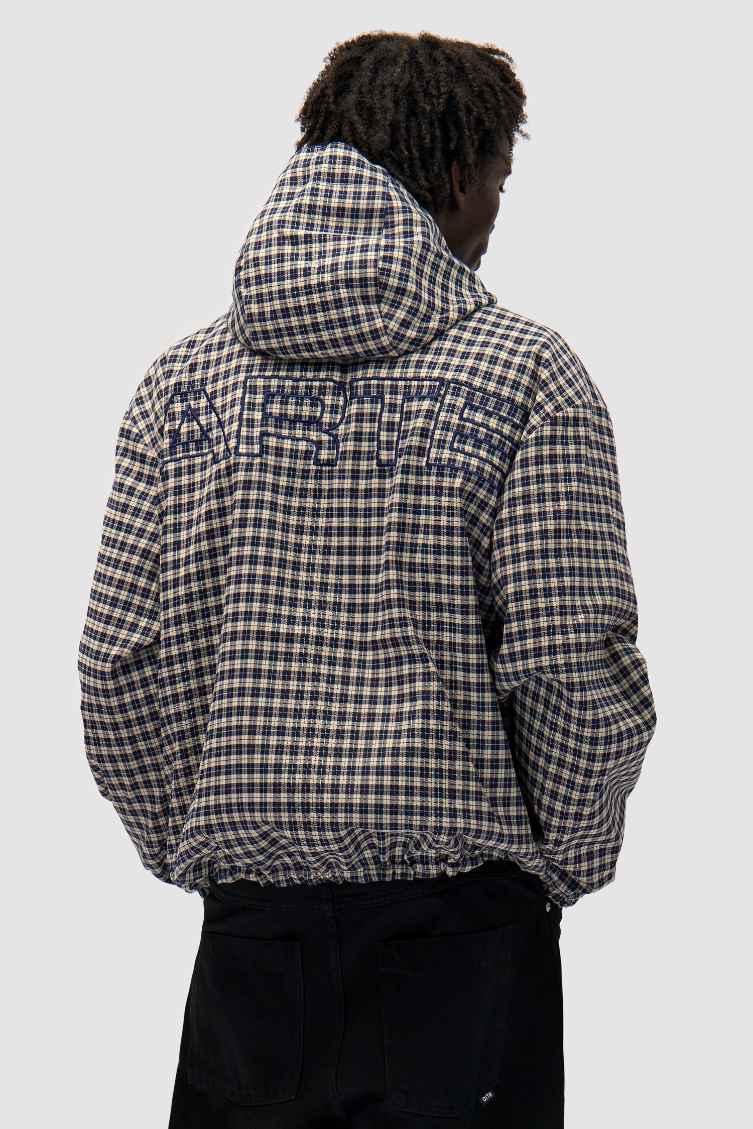 Reversible Plaid Technical Jacket in Navy/Plaid worn by a model, half-body back view, plaid side