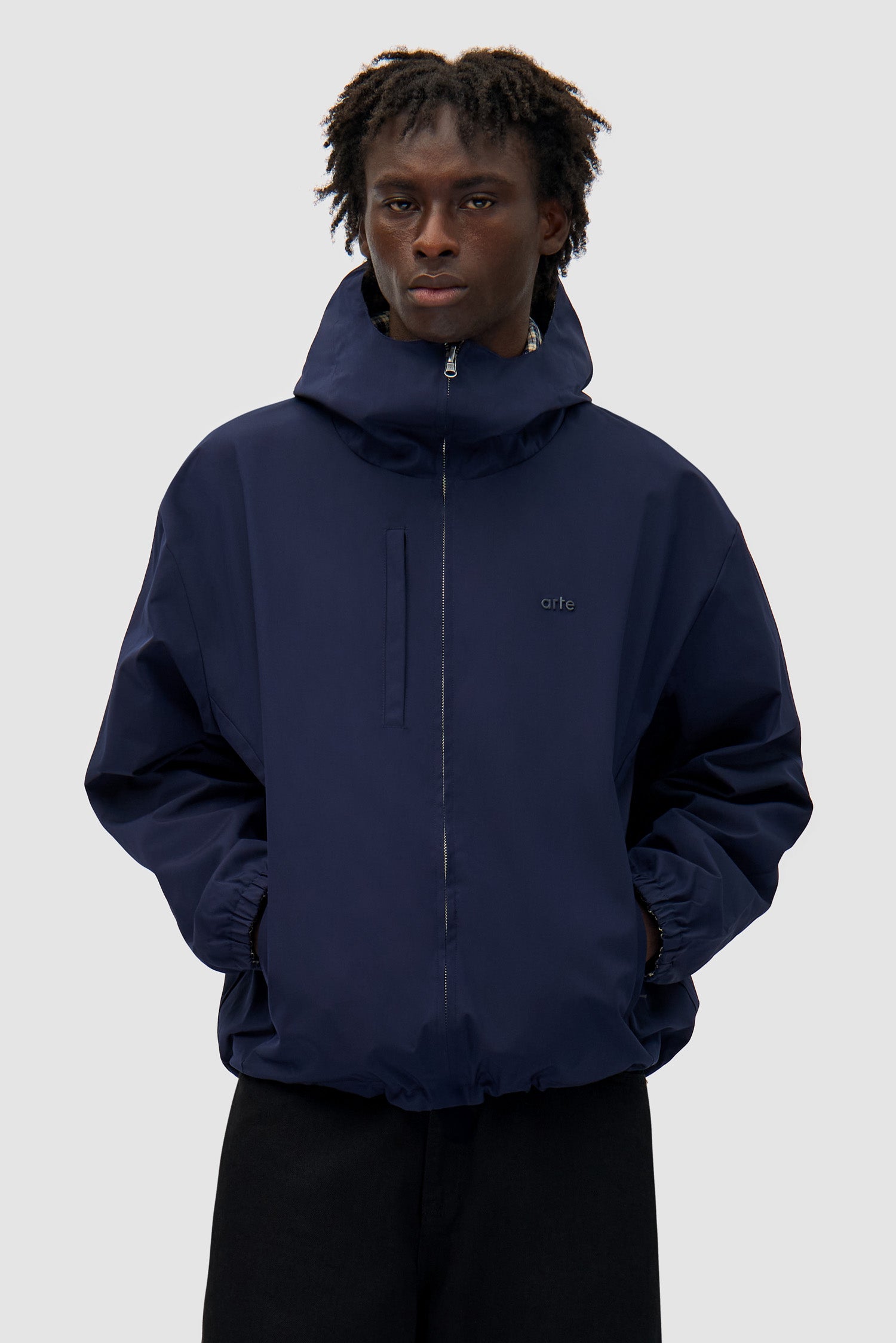 Reversible Plaid Technical Jacket in Navy/Plaid worn by a model, half-body front view, navy side