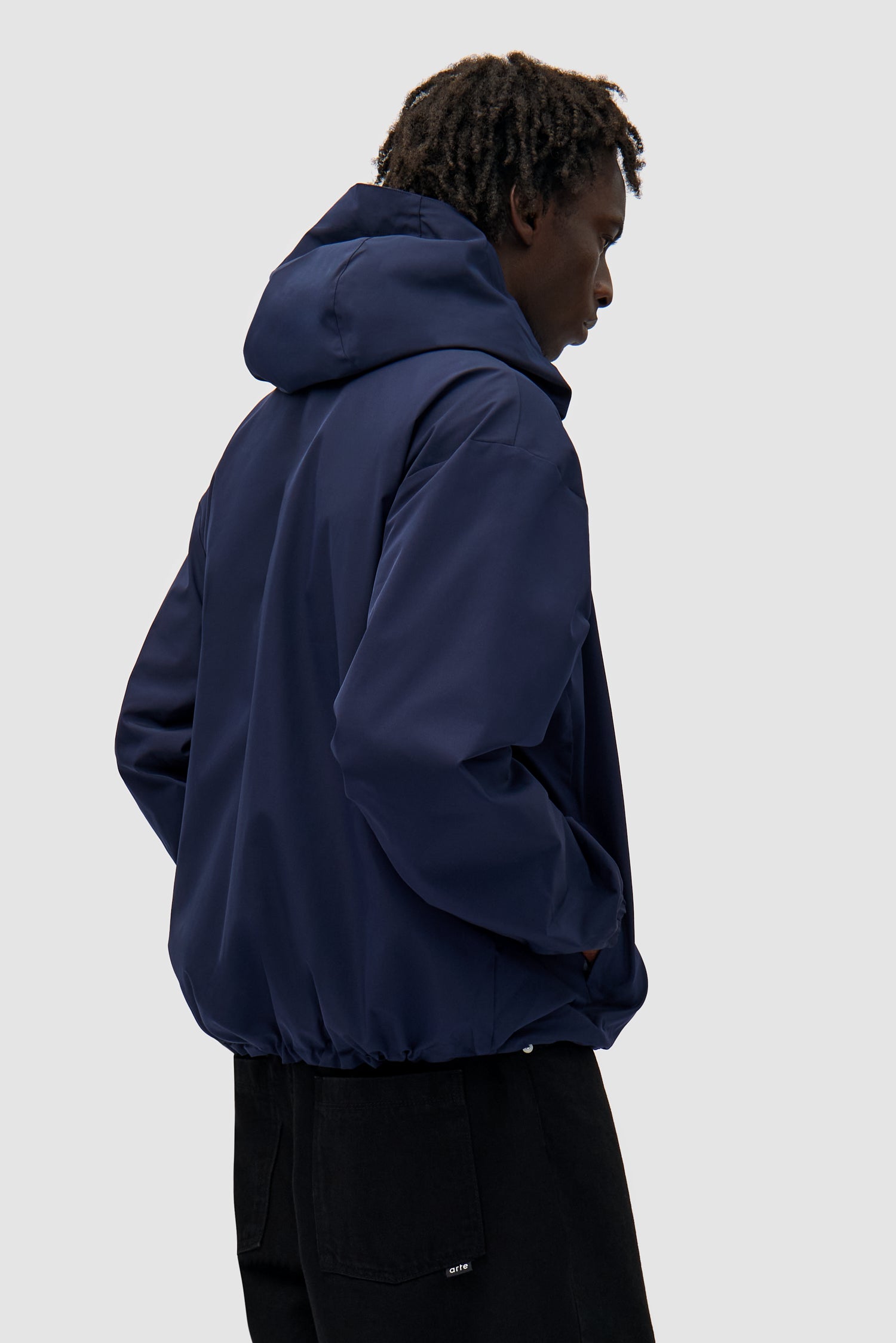 Reversible Plaid Technical Jacket in Navy/Plaid worn by a model, half-body side view