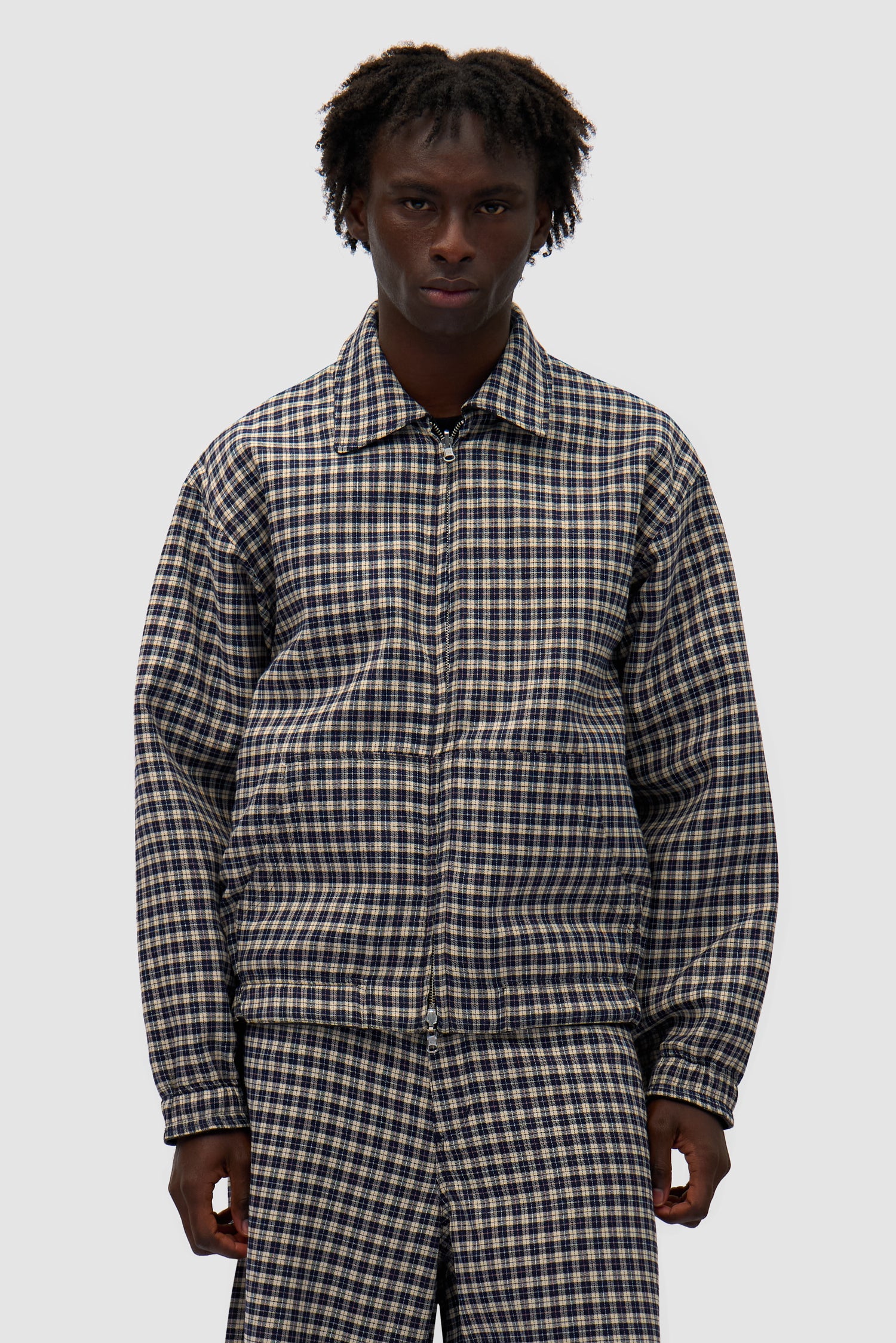 Reversible Plaid Leather Jacket in Black/Plaid worn reversed by a model, half-body front view