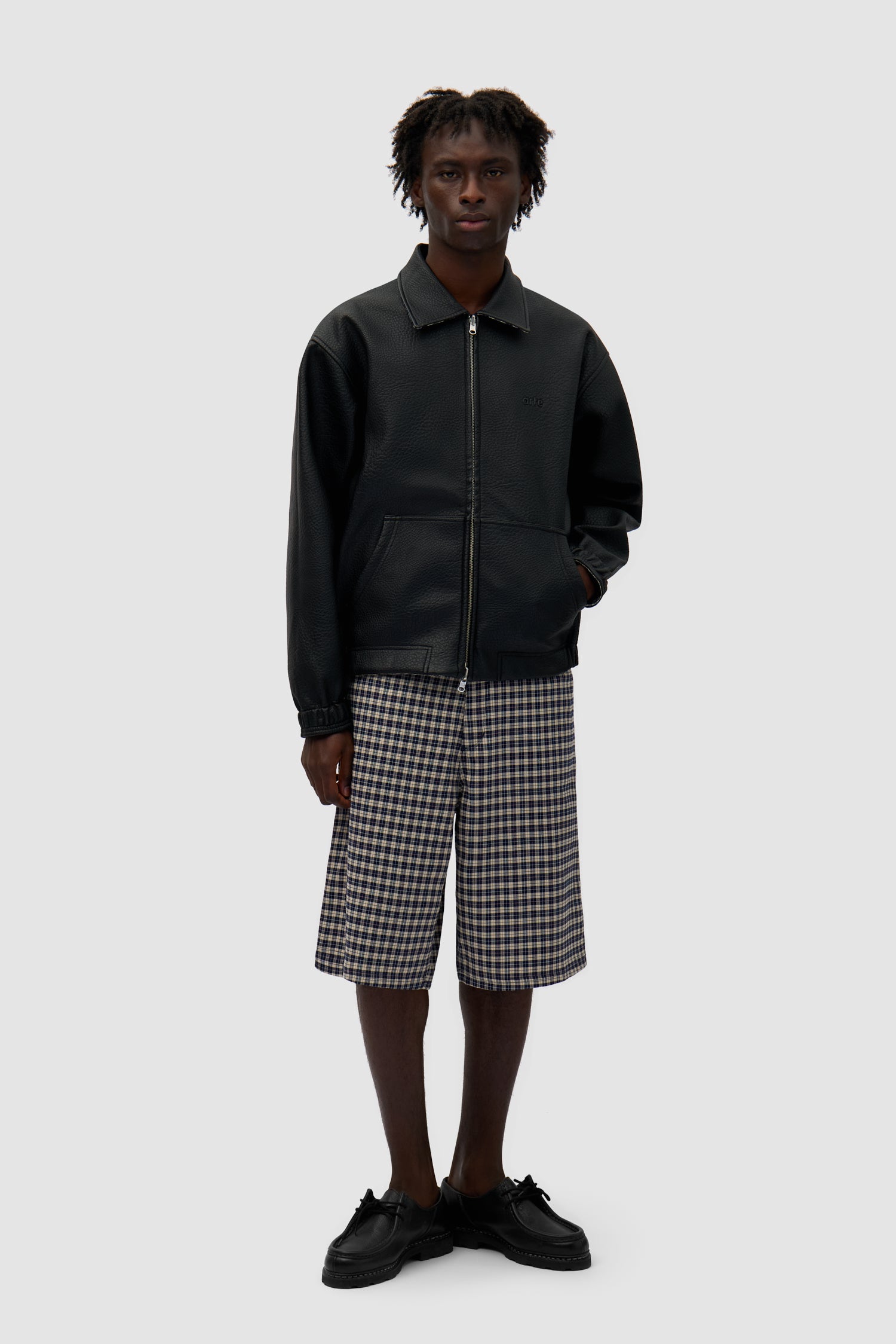 Reversible Plaid Leather Jacket in Black/Plaid worn by a model, full-body front view