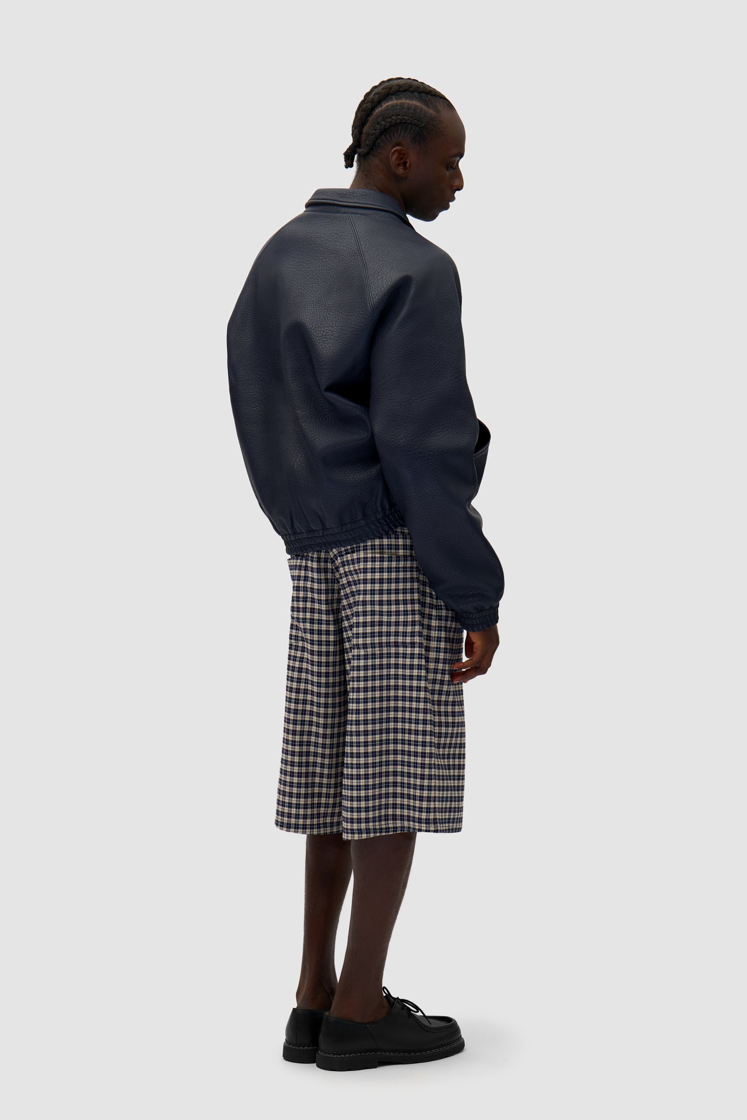 Big Logo Leather Jacket in Navy worn by a model, full-body back view