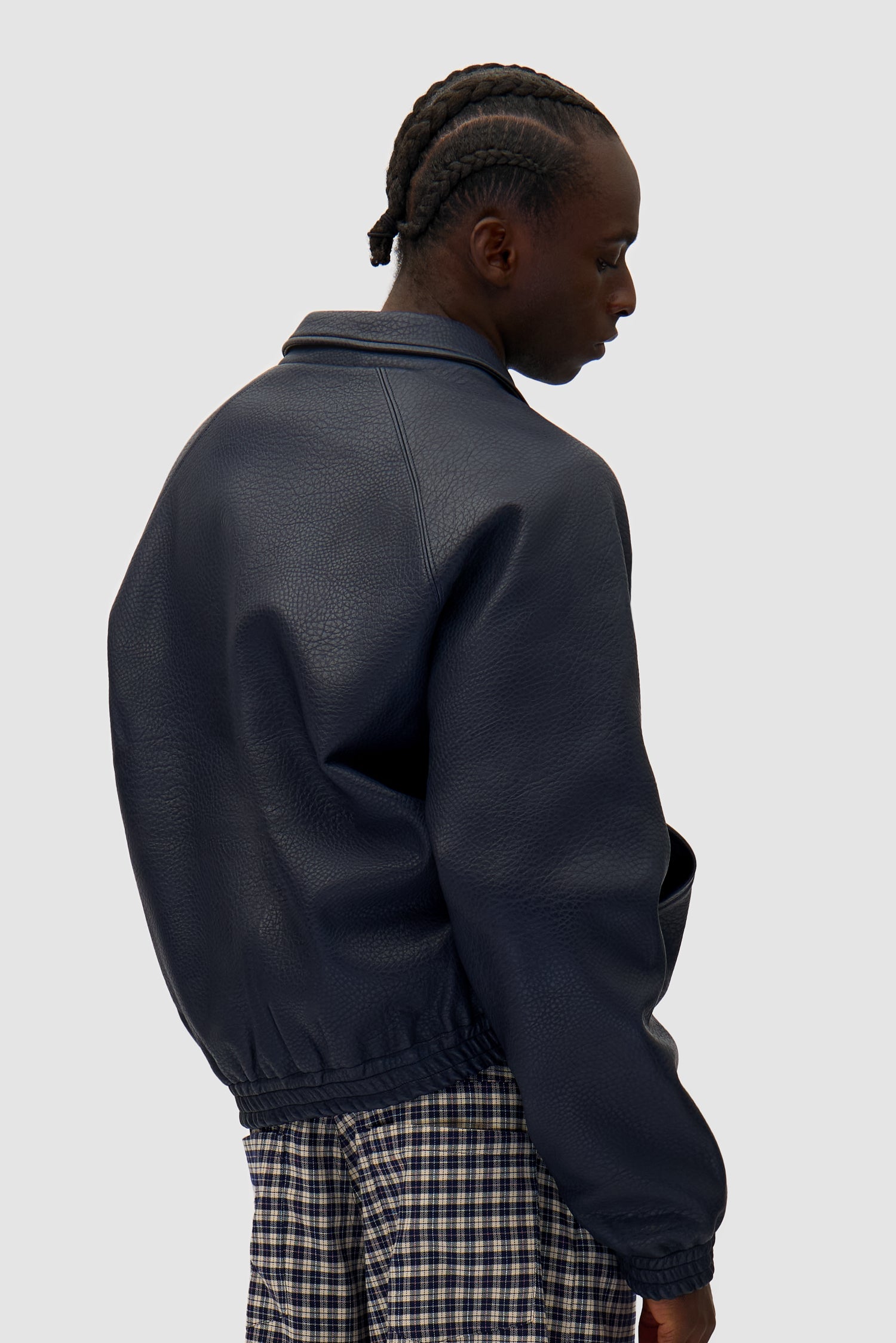 Big Logo Leather Jacket in Navy worn by a model, half-body back view