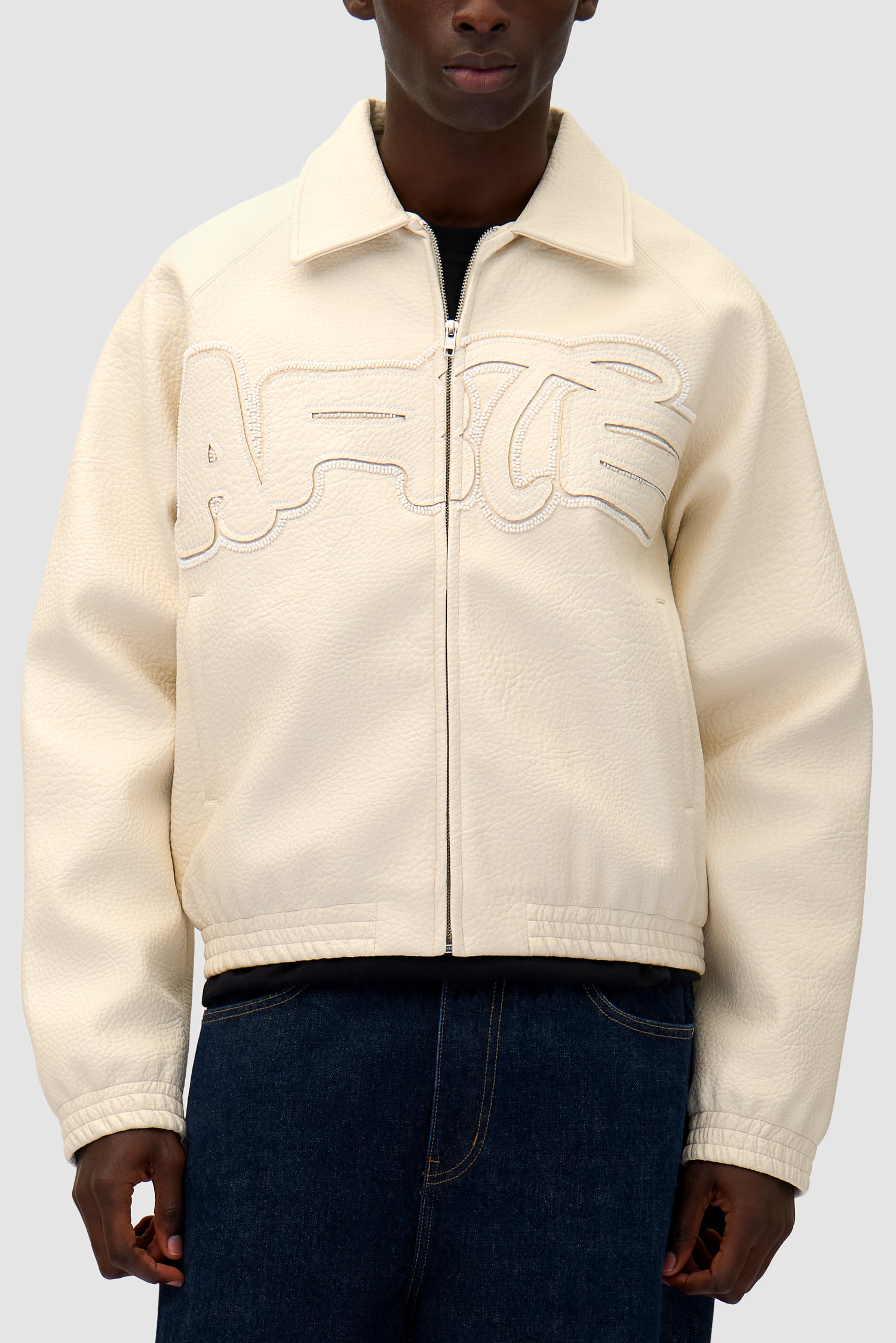 Big Logo Leather Jacket in Cream worn by a model, half-body detailed view