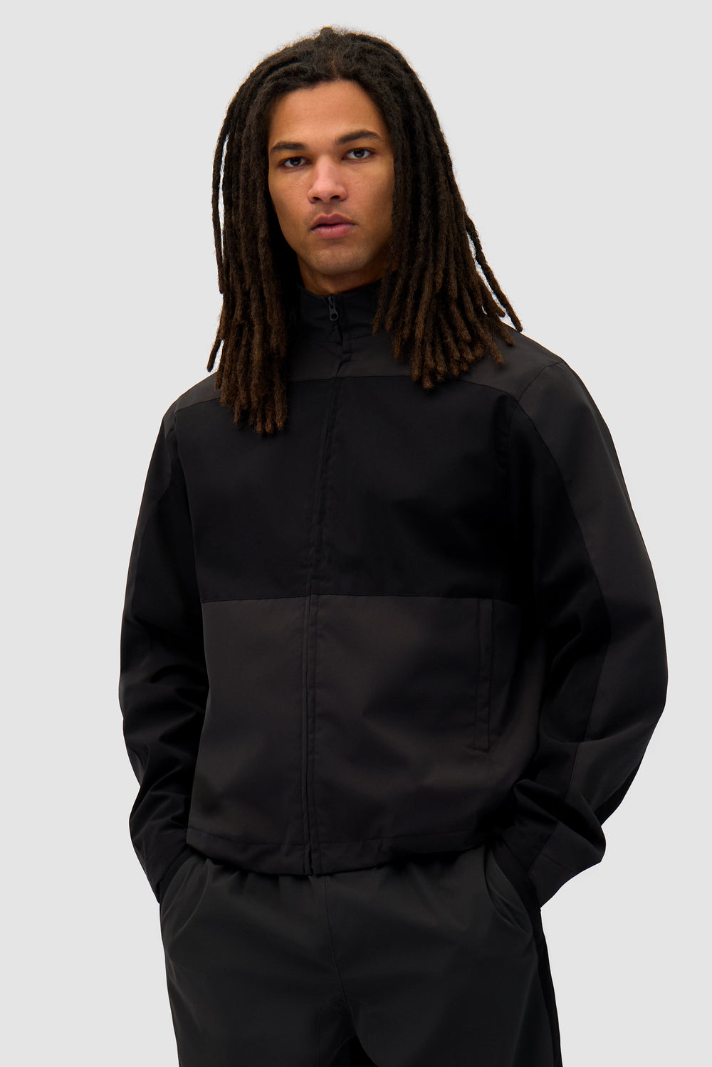Tracksuit Jacket in Black worn by a model, half-body front view