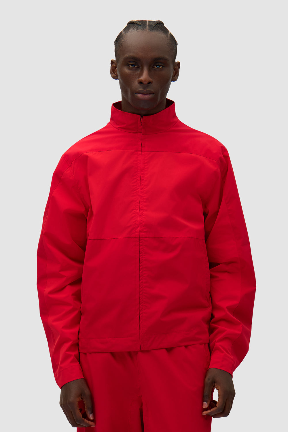 Tracksuit Jacket in Red worn by a model, half-body front view