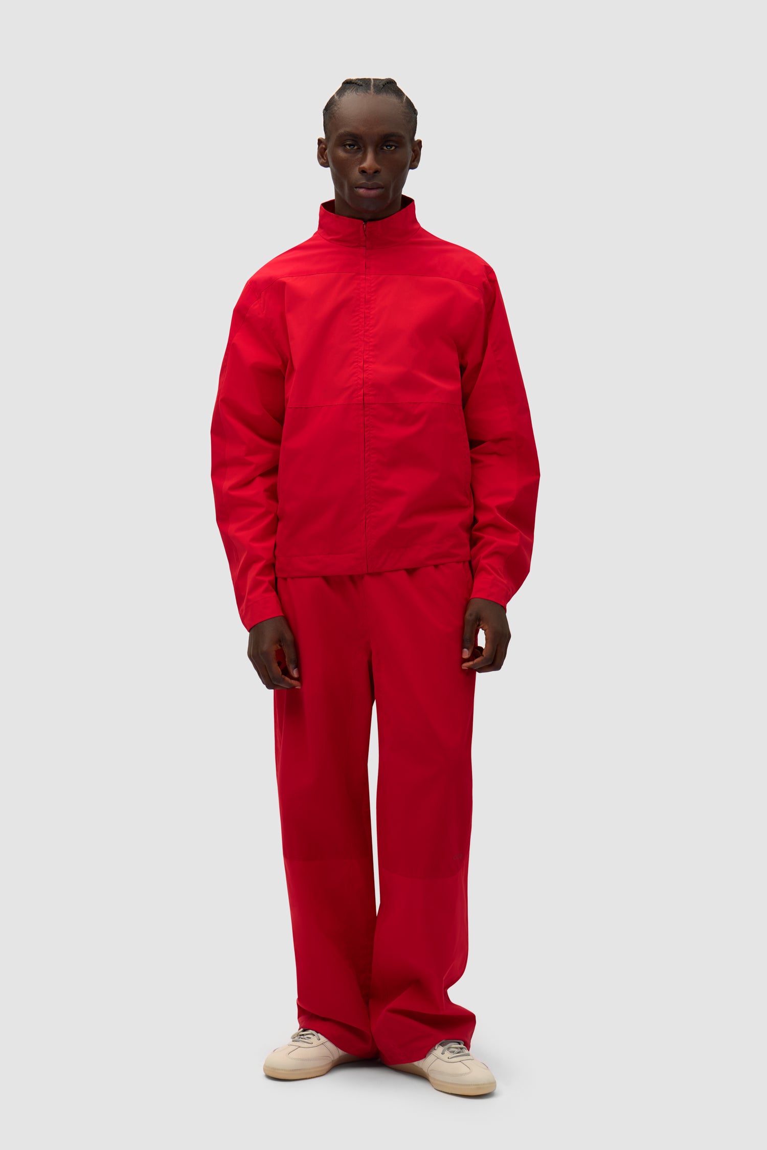 Tracksuit Pants in Red worn by a model, full-body front view