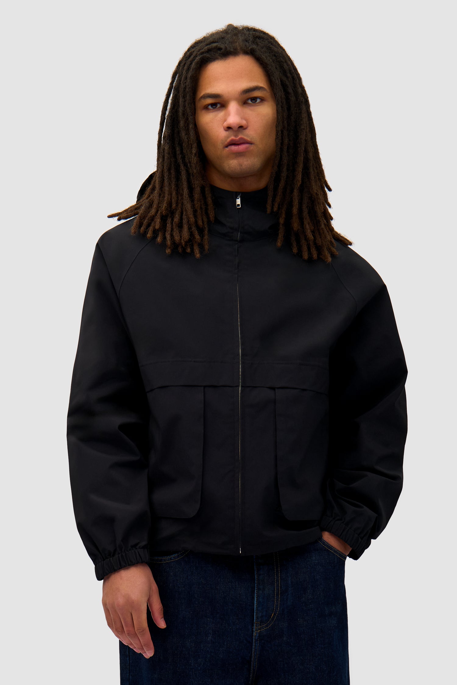 Bird Logo Anorak in Black worn by a model, half-body back view