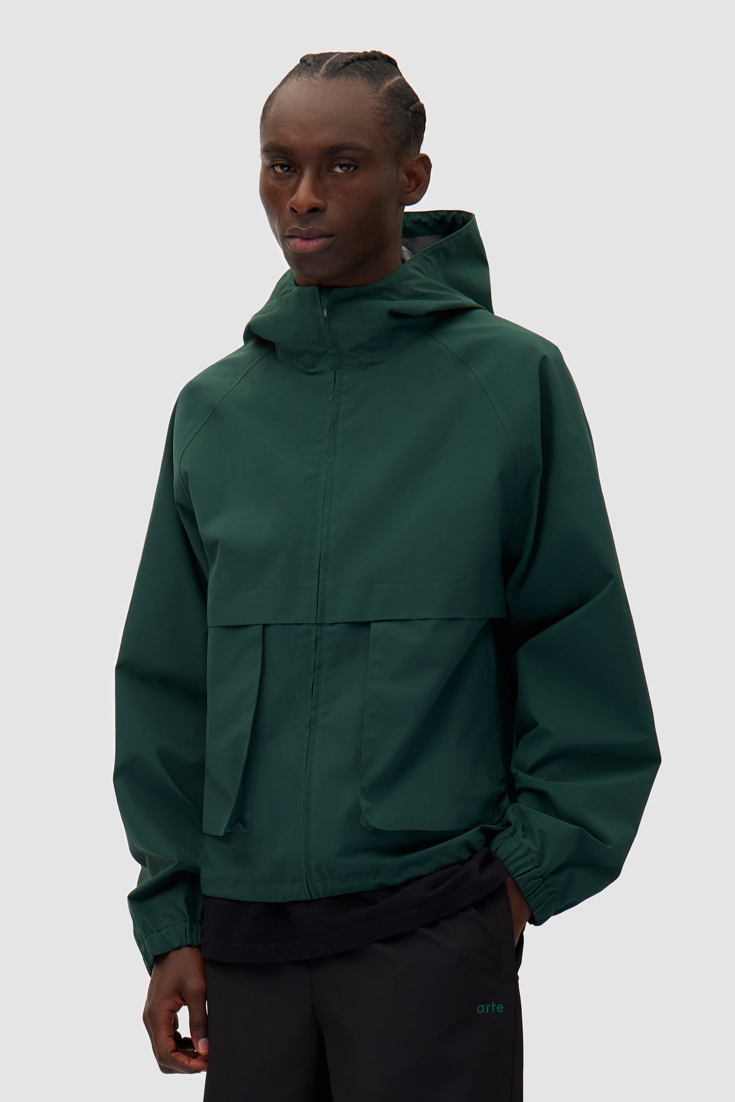 Bird Logo Anorak in Green worn by a model, half-body back view
