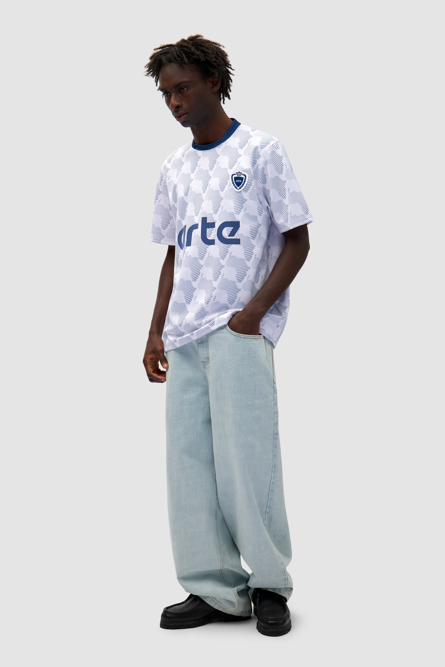 Footbal Shirt in White/Navy worn by a model, full-body side view