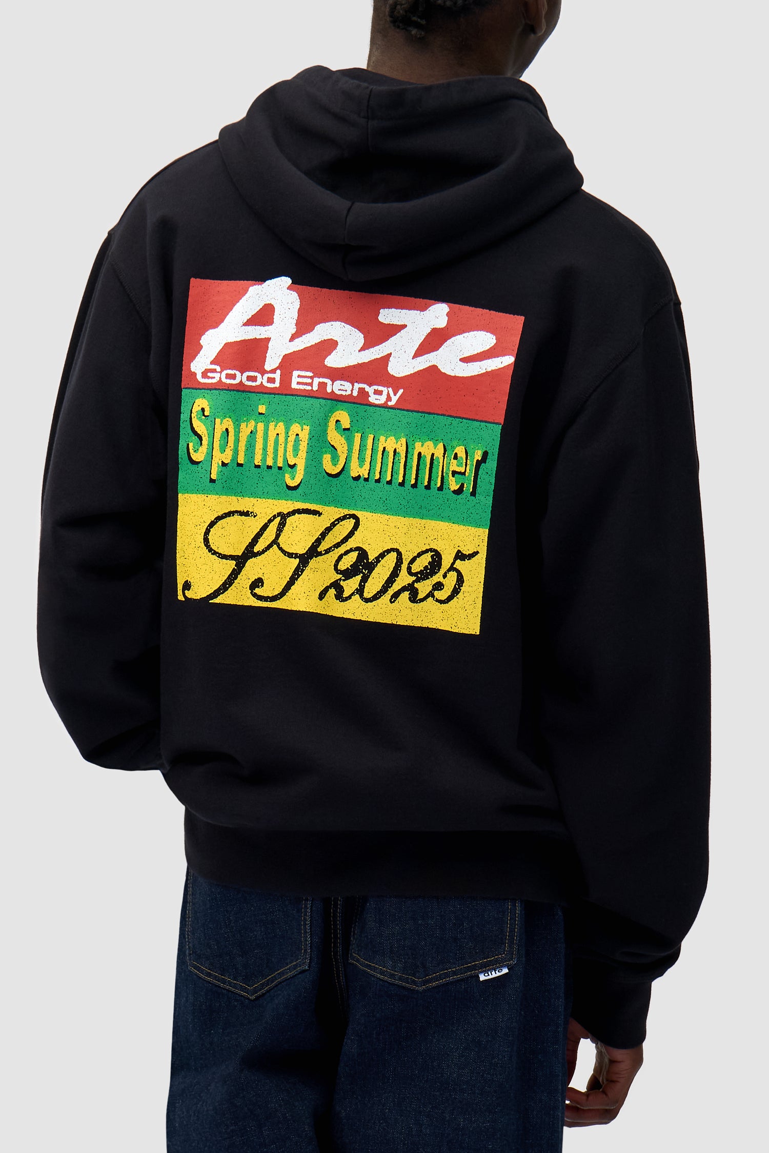 Energy Print Hoodie in Black worn by a model, full-body back view