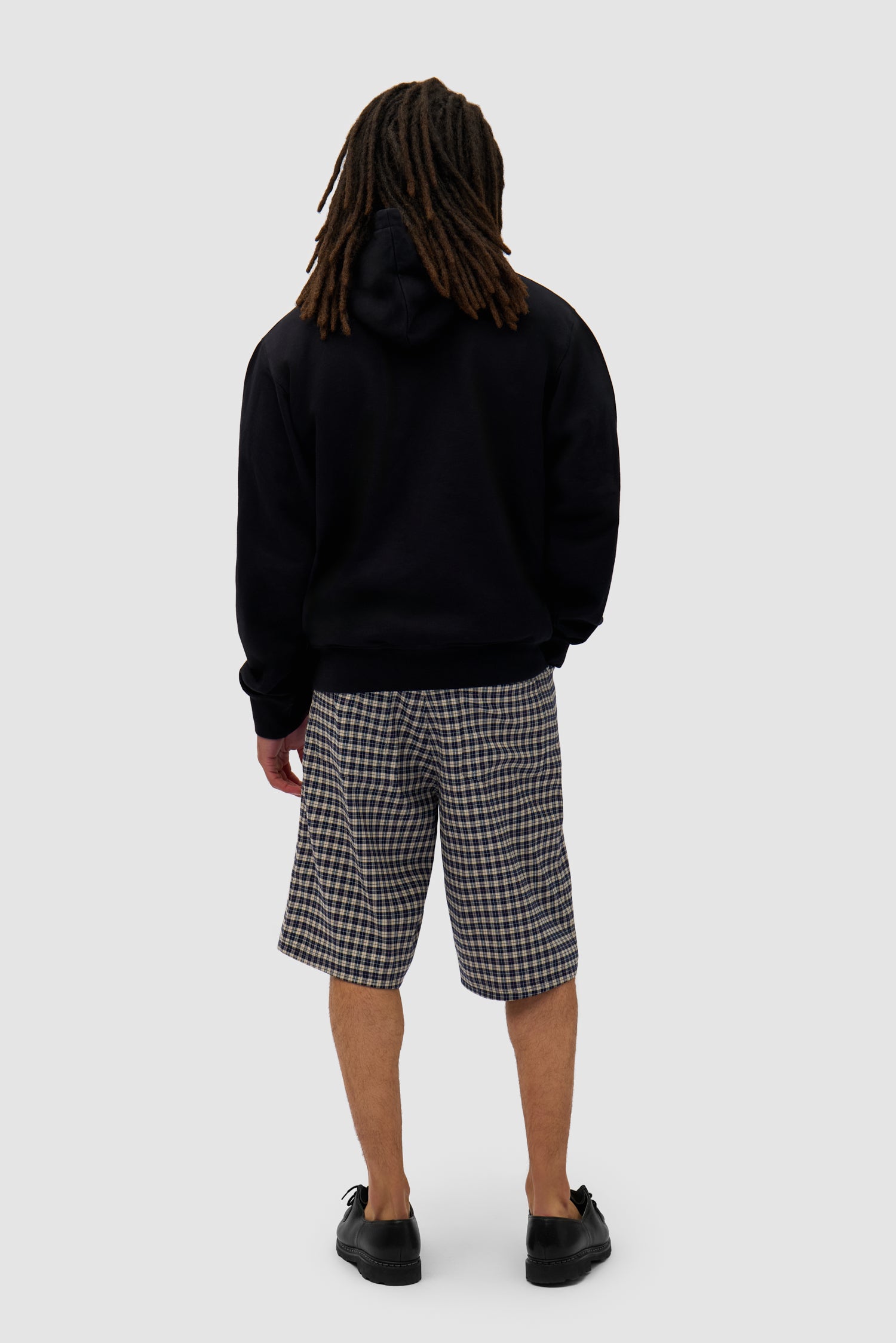 Big Bird Hoodie in Black worn by a model, full-body back view