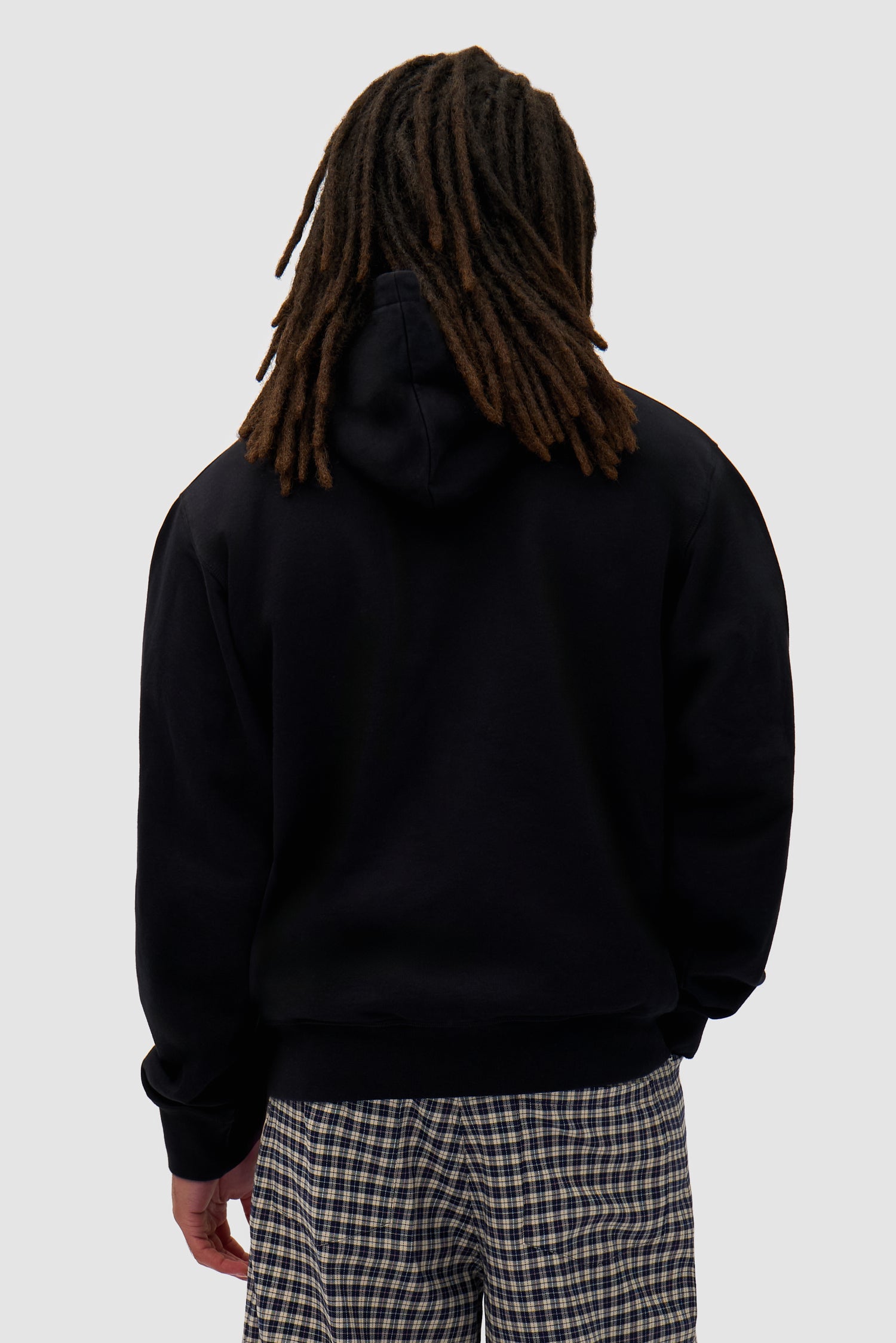 Big Bird Hoodie in Black worn by a model, half-body back view