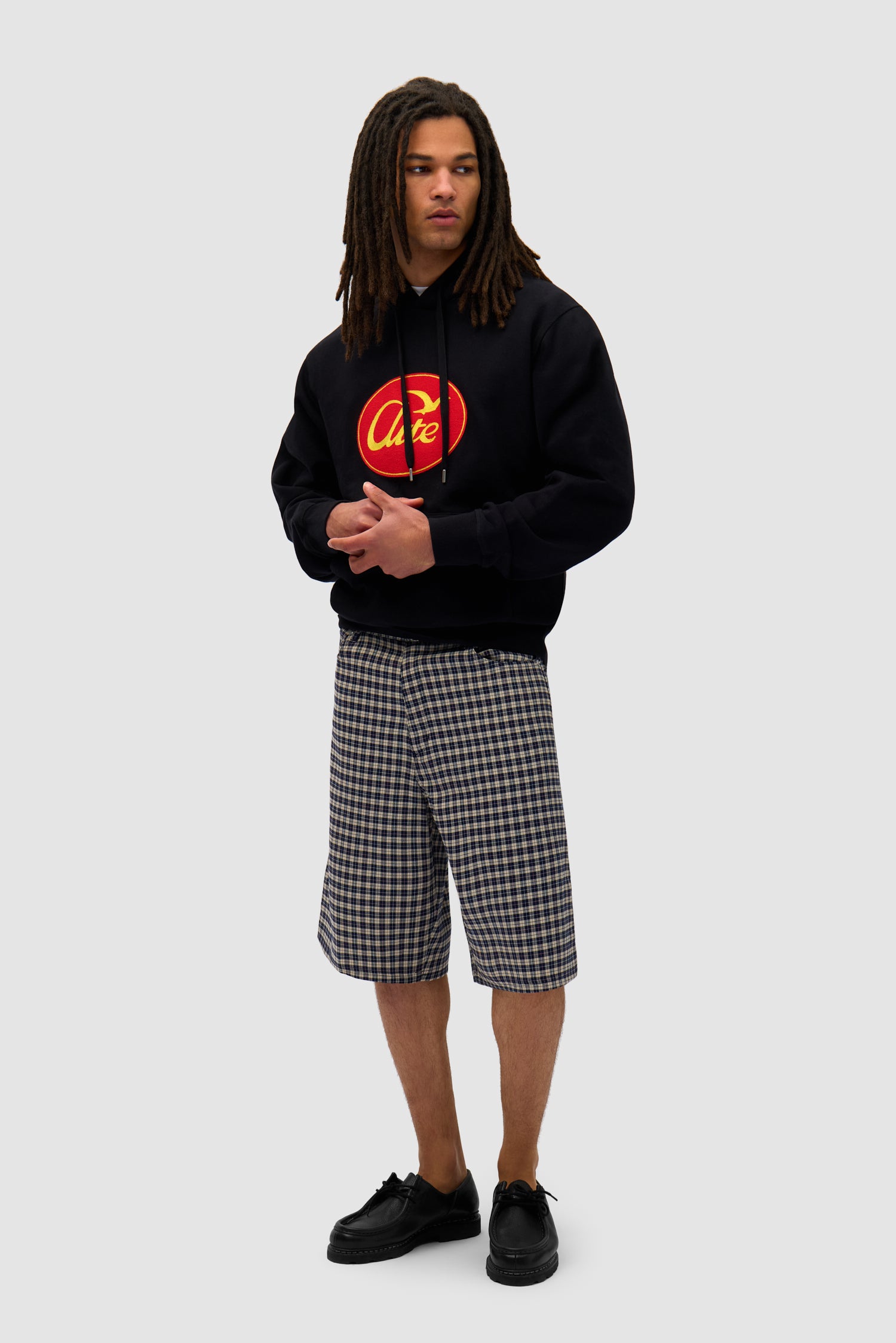 Big Bird Hoodie in Black worn by a model, full-body side view