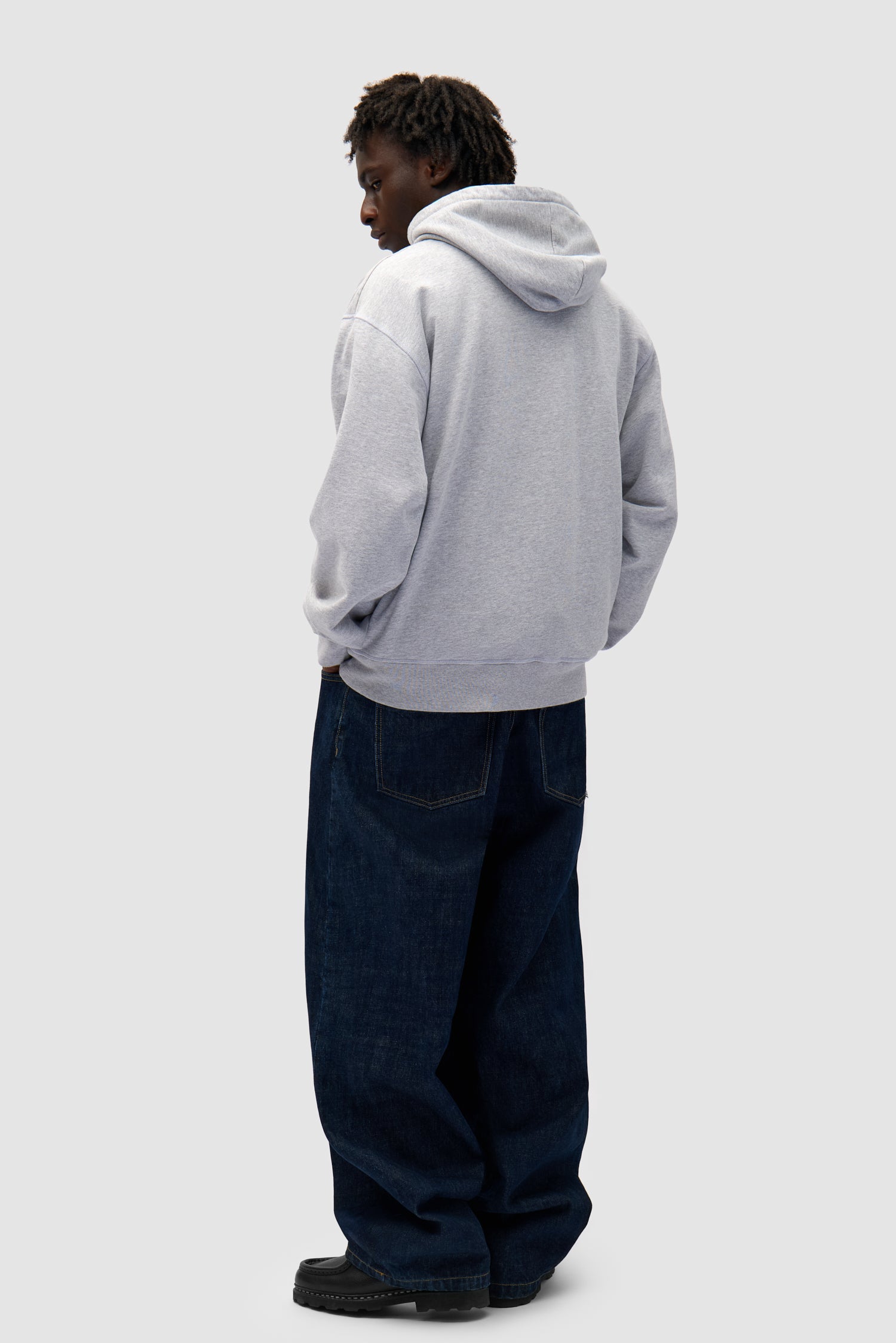 Big Bird Hoodie in Grey worn by a model, full-body side view