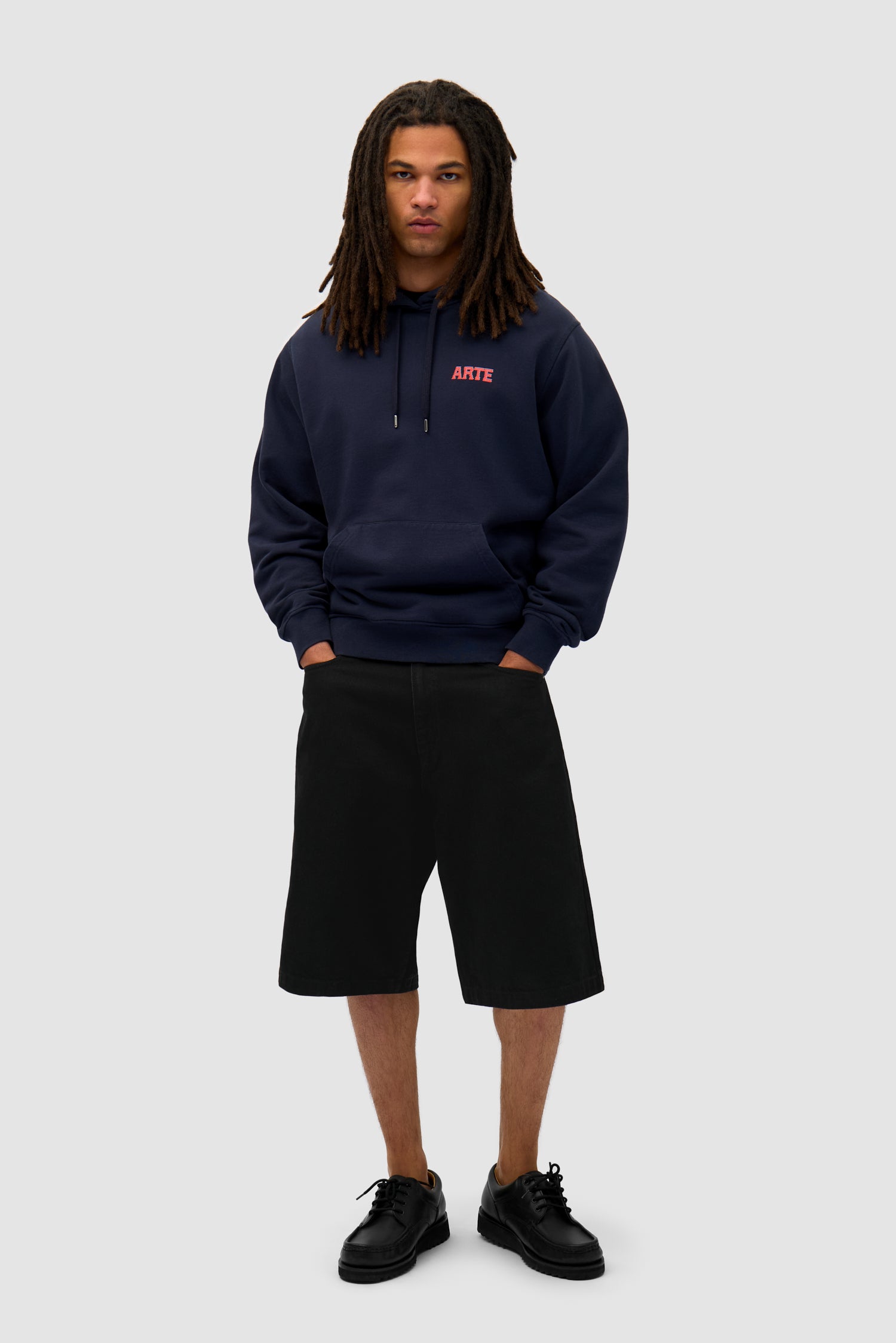 Mural Back Print Hoodie in Navy worn by a model, full-body front view