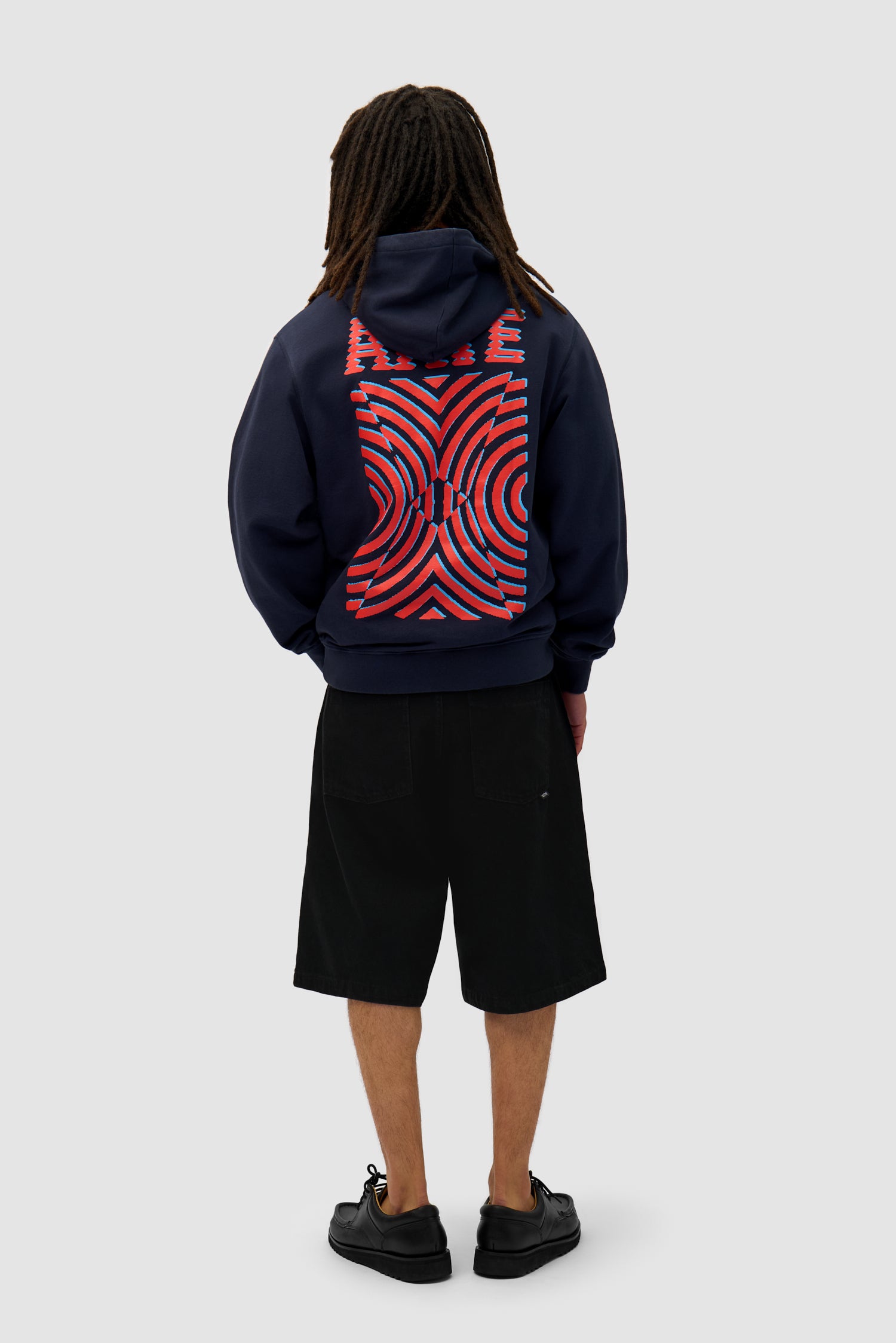 Mural Back Print Hoodie in Navy worn by a model, full-body back view