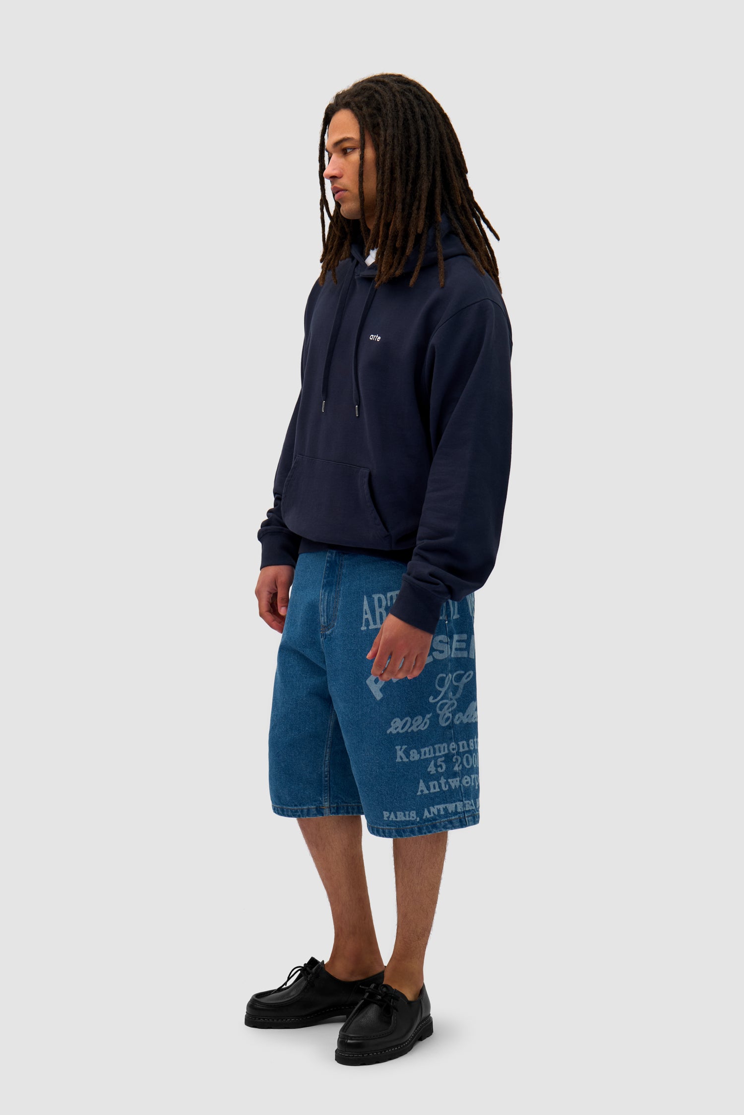 Back Sun & Moon Hoodie in Navy worn by a model, full-body side view