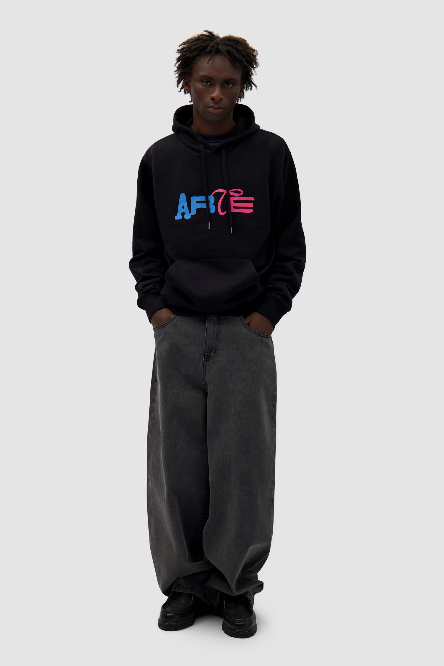 Duo Logo Hoodie in Black worn by a model, full-body front view