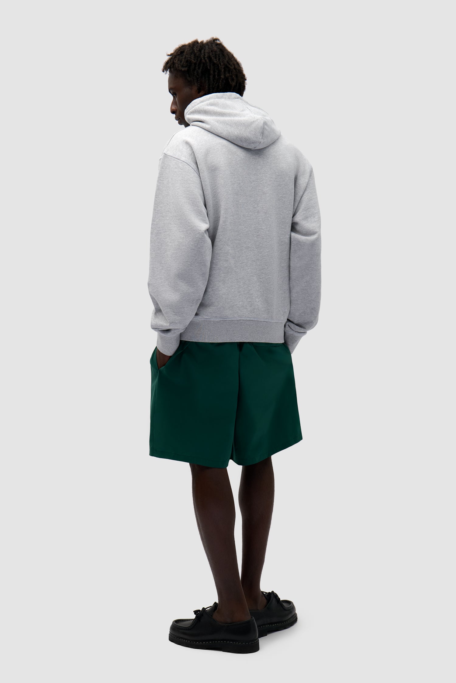 Duo Logo Hoodie in Grey worn by a model, full-body back view