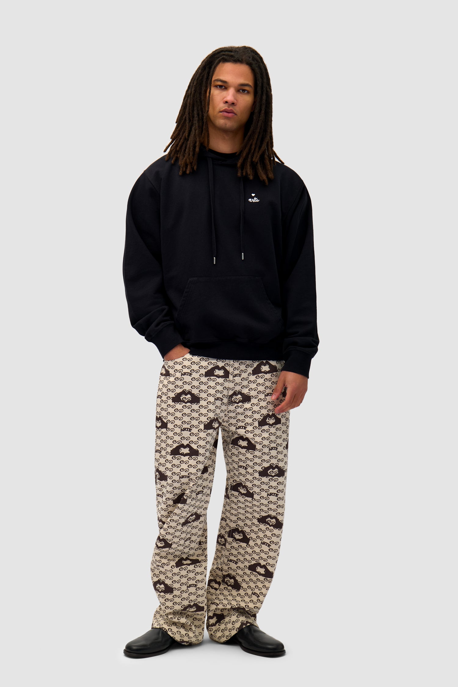 Heart Logo Hoodie in Black worn by a model, full-body front view