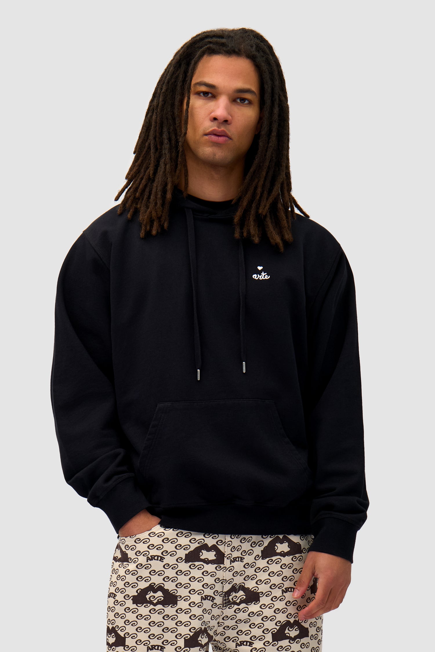 Heart Logo Hoodie in Black worn by a model, half-body front view