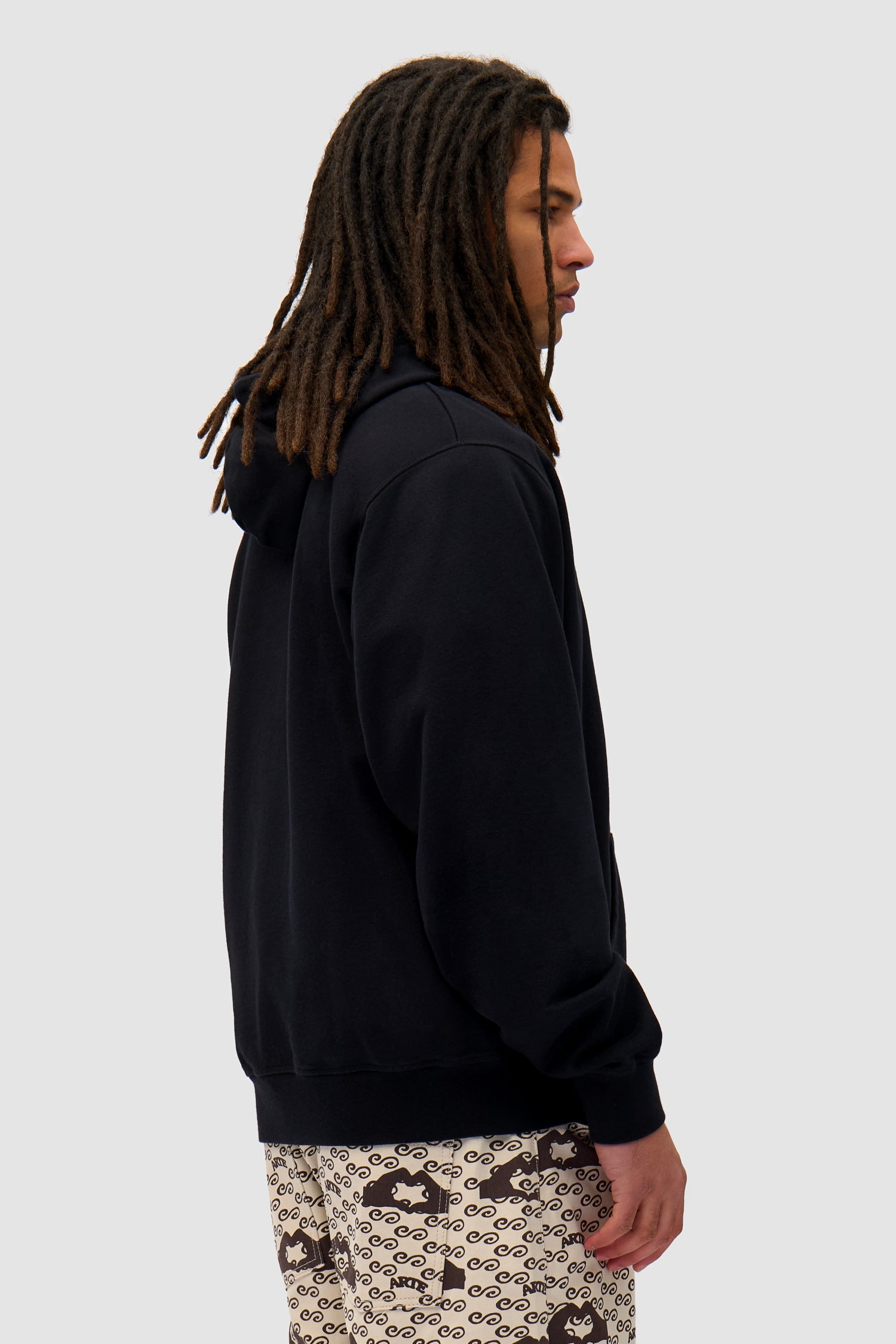 Heart Logo Hoodie in Black worn by a model, half-body back view
