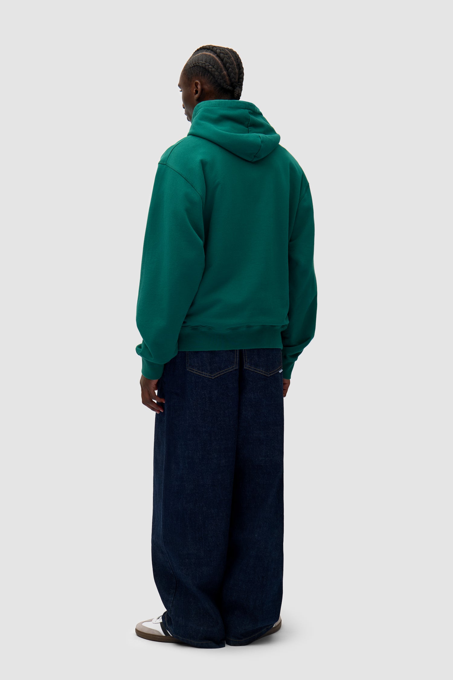 Heart Logo Hoodie in Green worn by a model, full-body back view