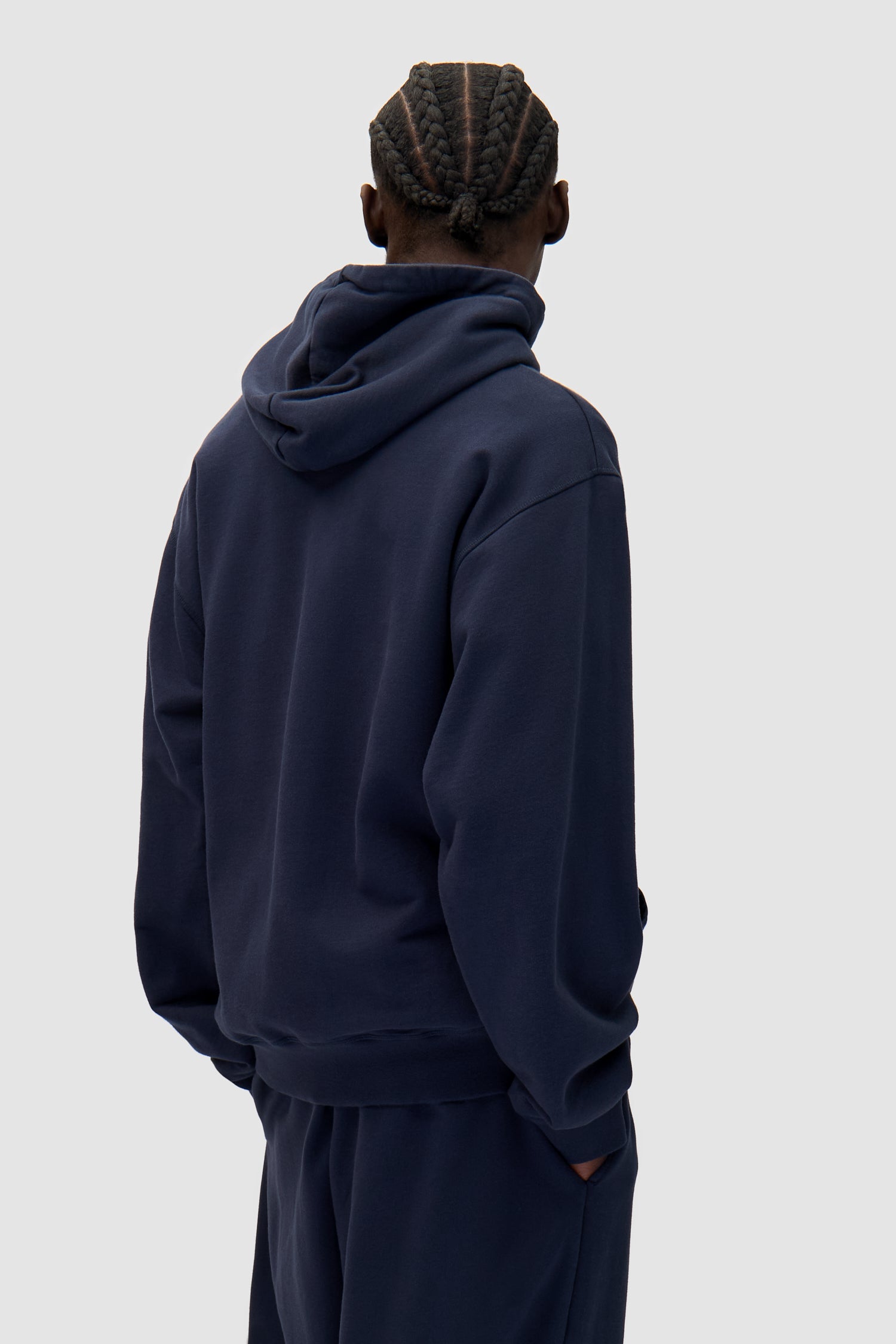 Heart Logo Hoodie in Navy worn by a model, half-body back view