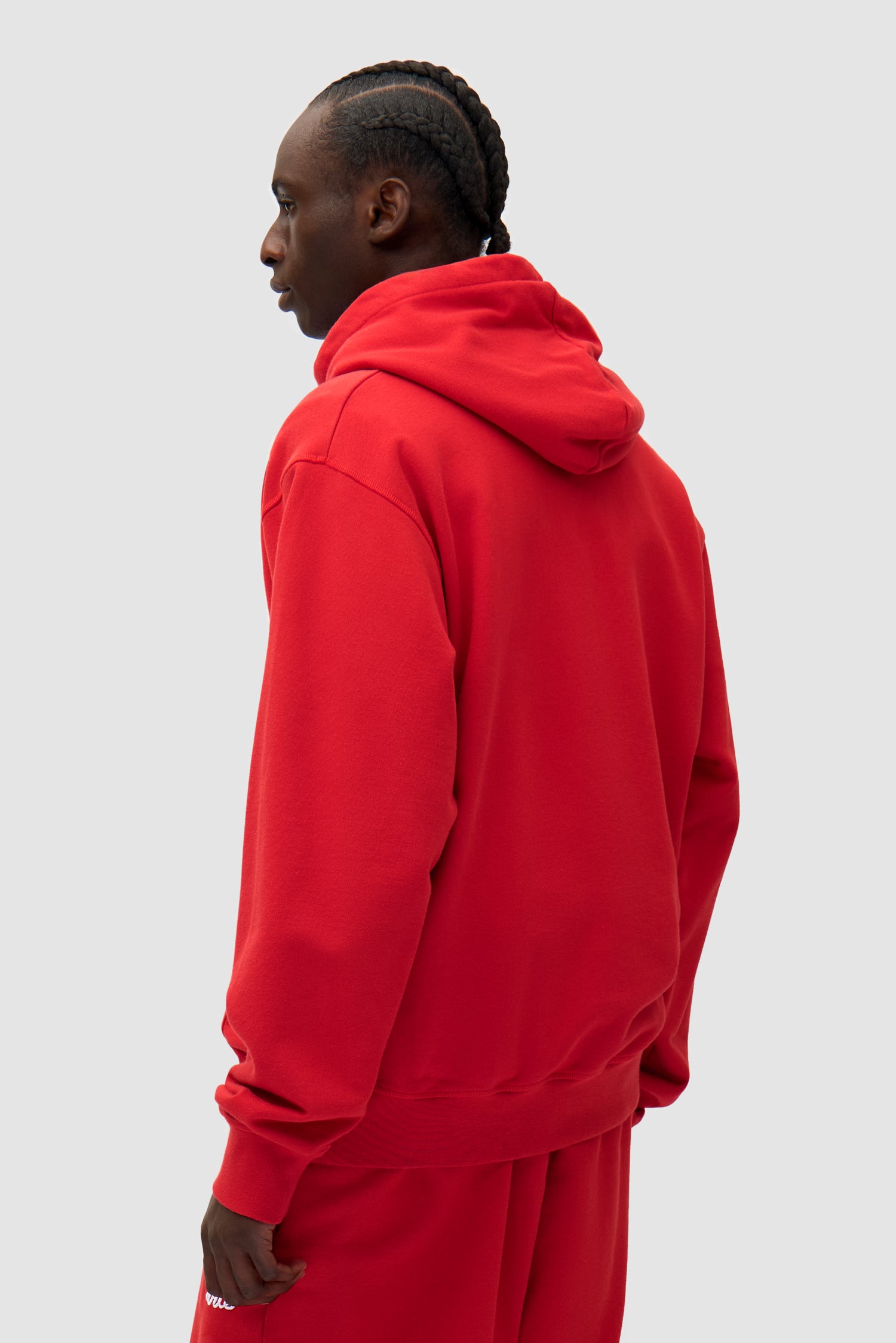 Heart Logo Hoodie in Red worn by a model, half-body back view