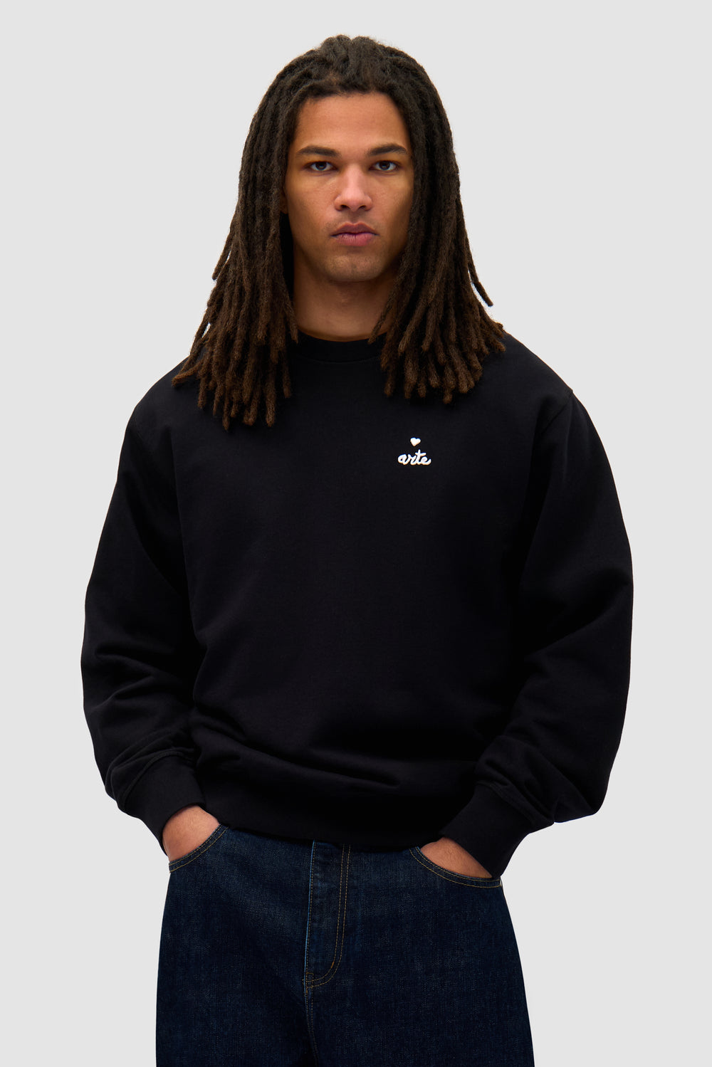 Heart Crewneck in Black worn by a model, half-body front view