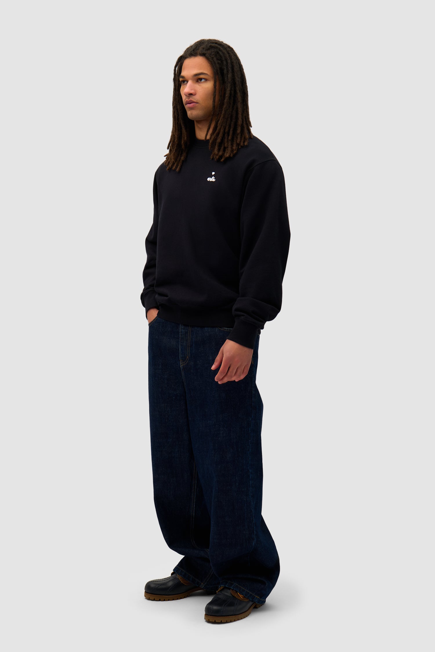 Heart Crewneck in Black worn by a model, full-body side view