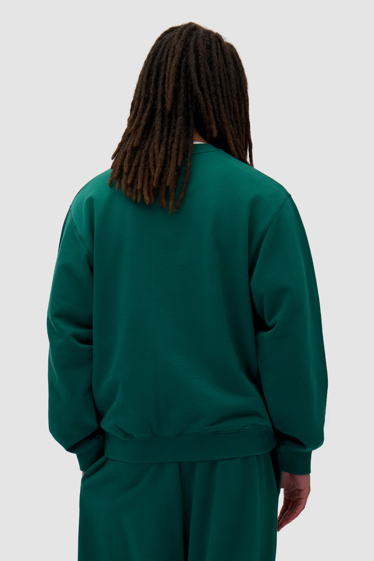 Heart Crewneck in Green worn by a model, half-body back view