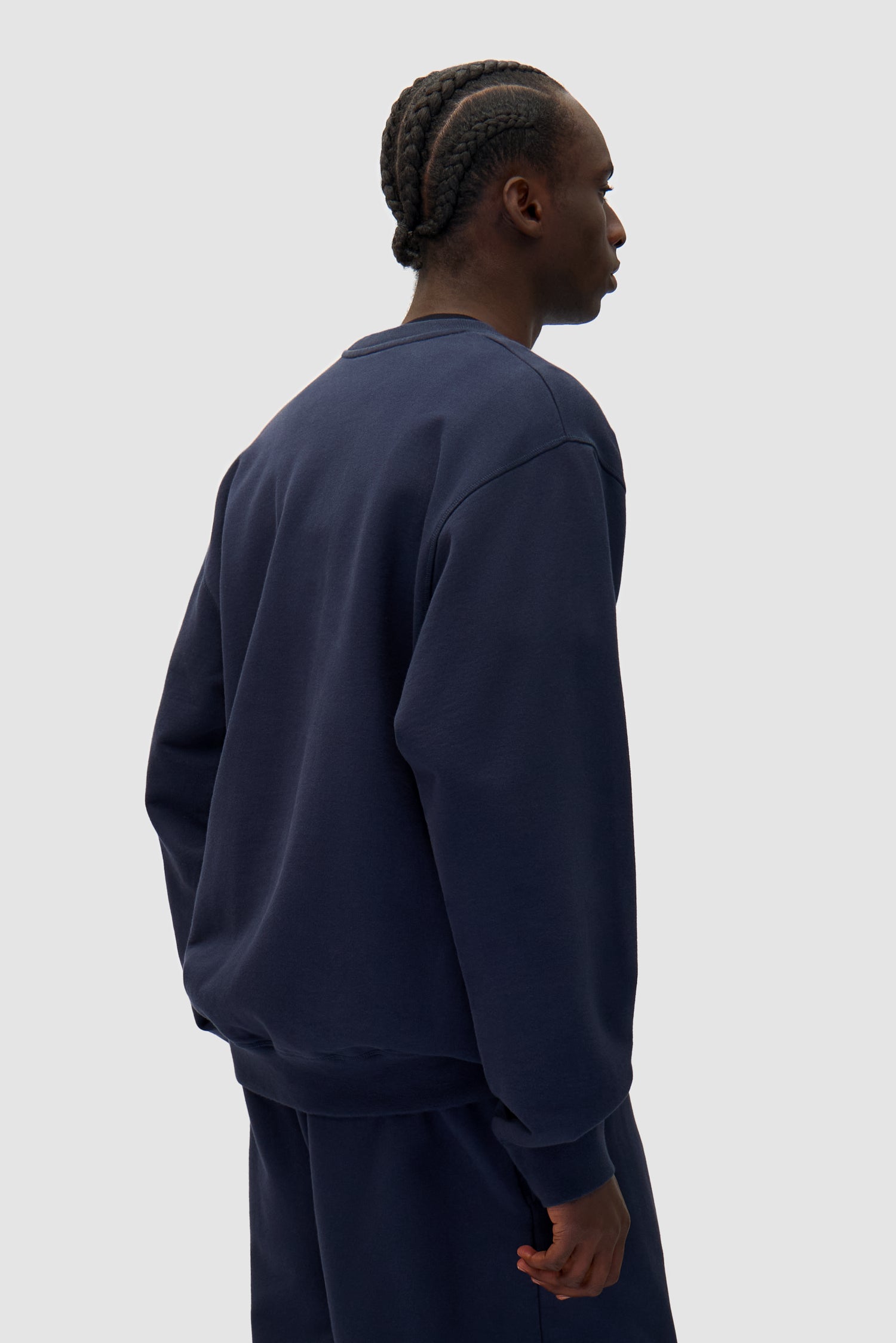 Heart Crewneck in Navy worn by a model, half-body back view