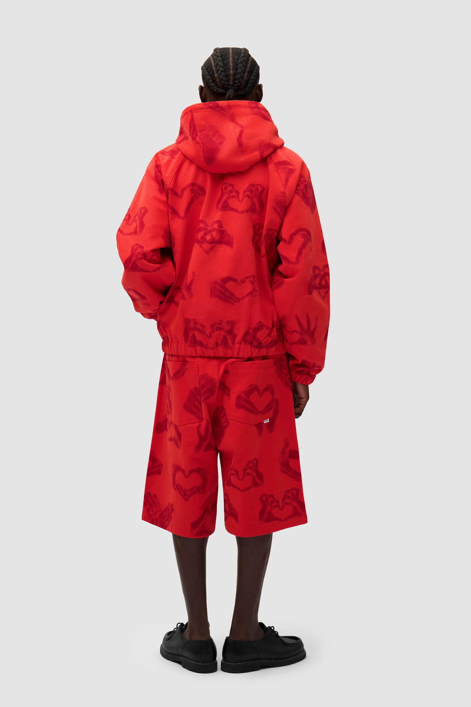 Hands Print Jacket in Red worn by a model, full-body back view