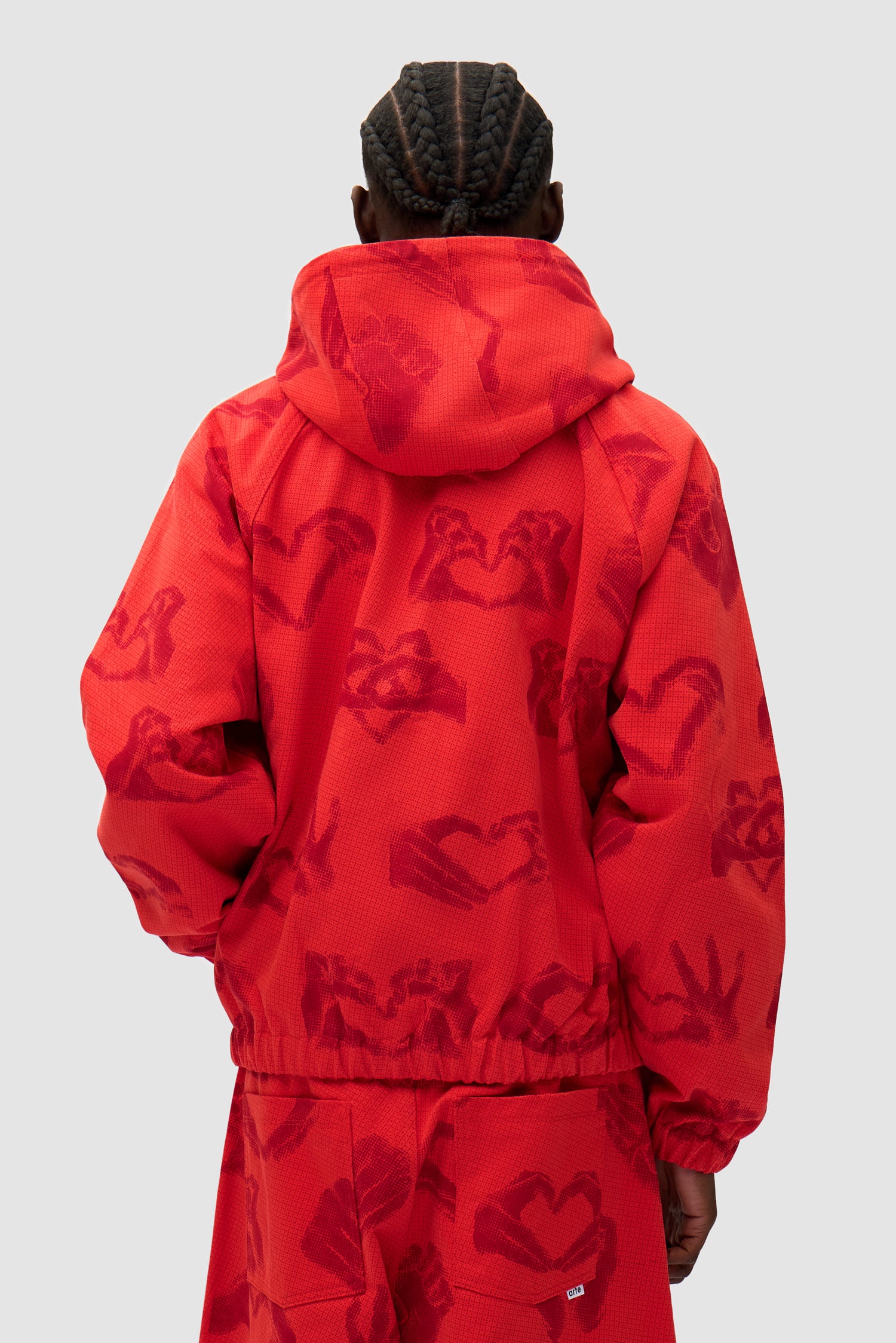 Hands Print Jacket in Red worn by a model, half-body back view