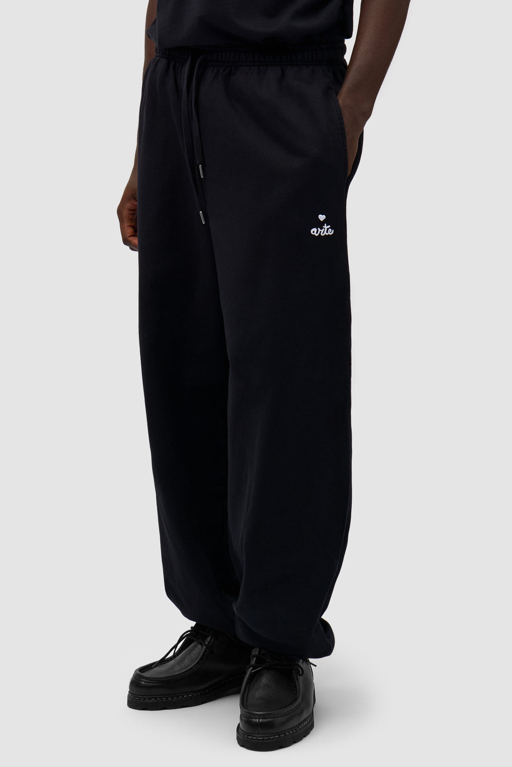 Heart Logo Sweatpants in Black worn by a model, half-body front view