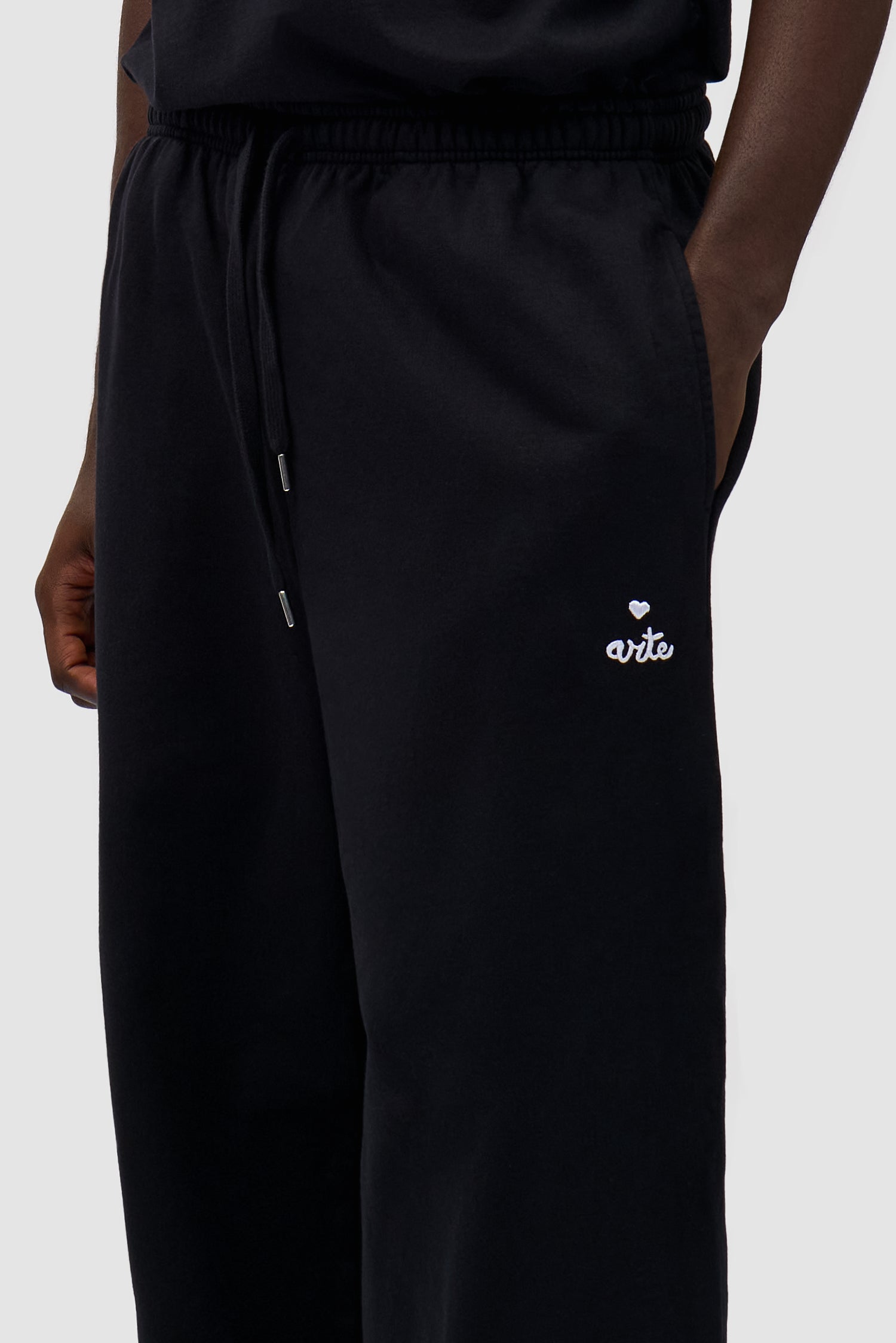 Heart Logo Sweatpants in Black worn by a model, showing the logo detail